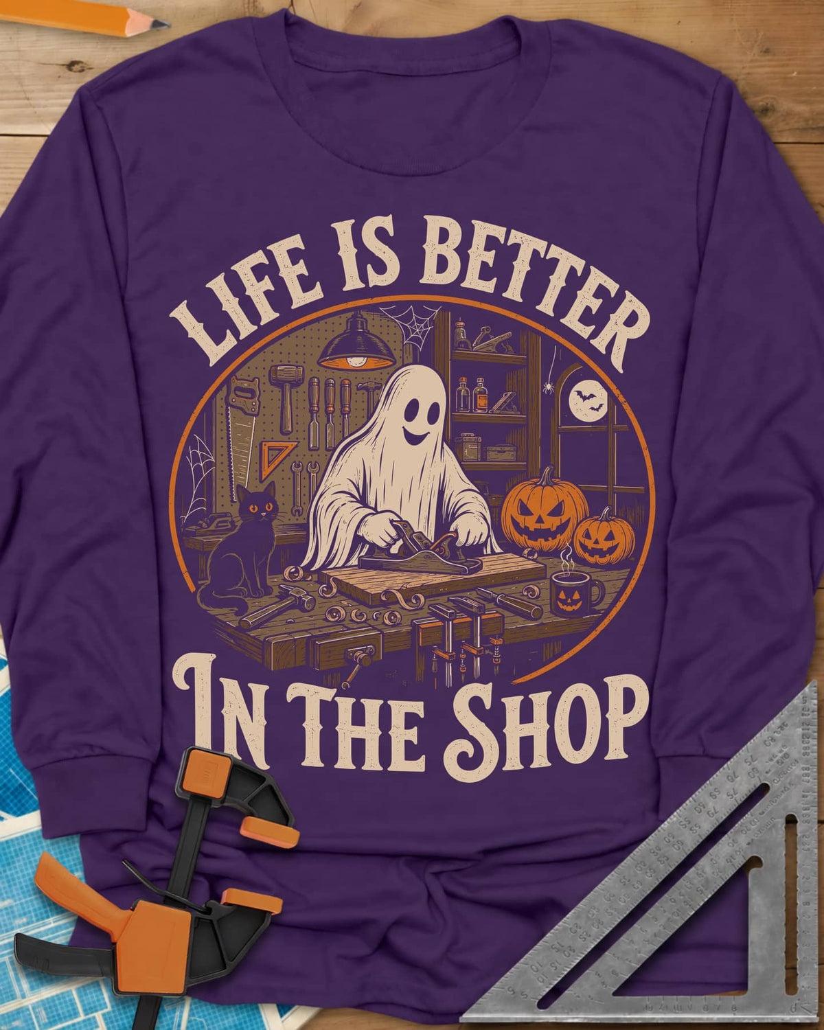 Shop Life long sleeve shirt in Purple, a smiling ghost planing a board beside a cat and pumpkins