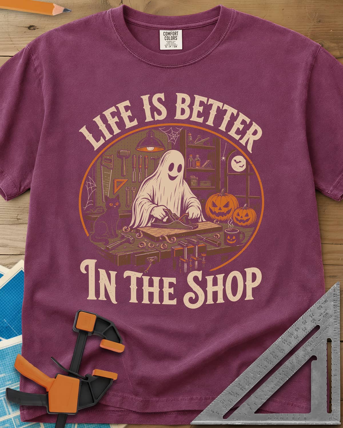 Shop Life heavyweight tee in Berry, a smiling ghost planing a board beside a cat and pumpkins