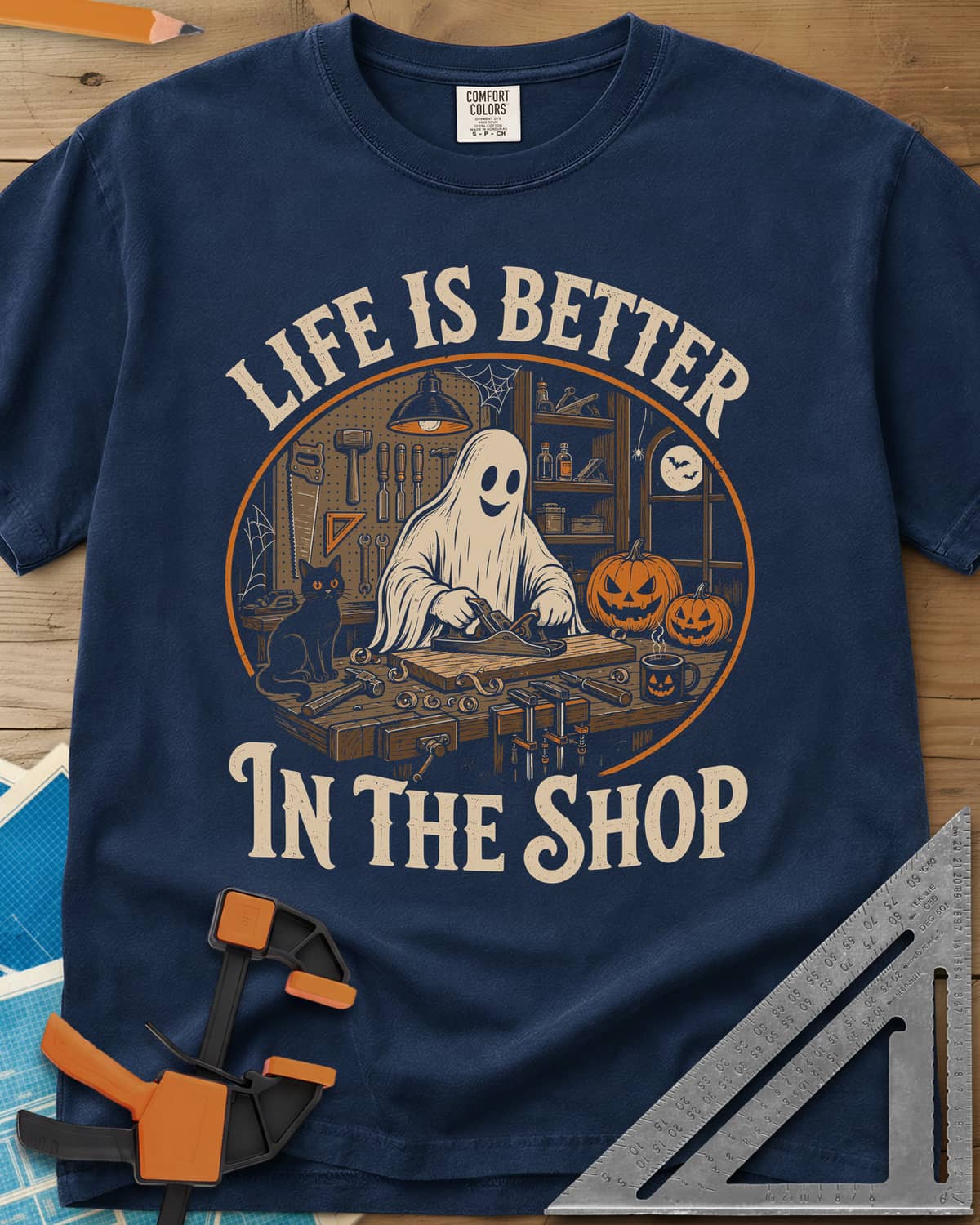 Shop Life heavyweight tee in Navy, a smiling ghost planing a board beside a cat and pumpkins