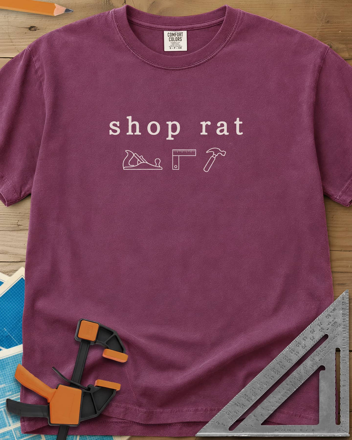 Shop Rat heavyweight tee in Berry, a hand plane, a square and a hammer in thin outline