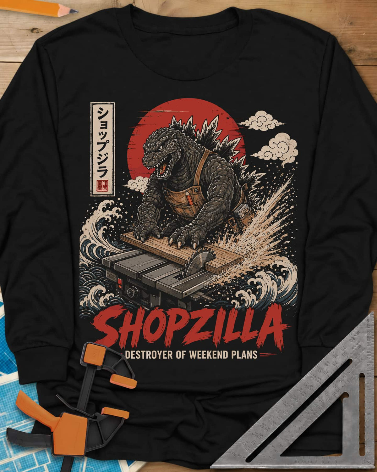 Shopzilla long sleeve shirt in Black, a monster in a tool apron pushing a board through a table saw