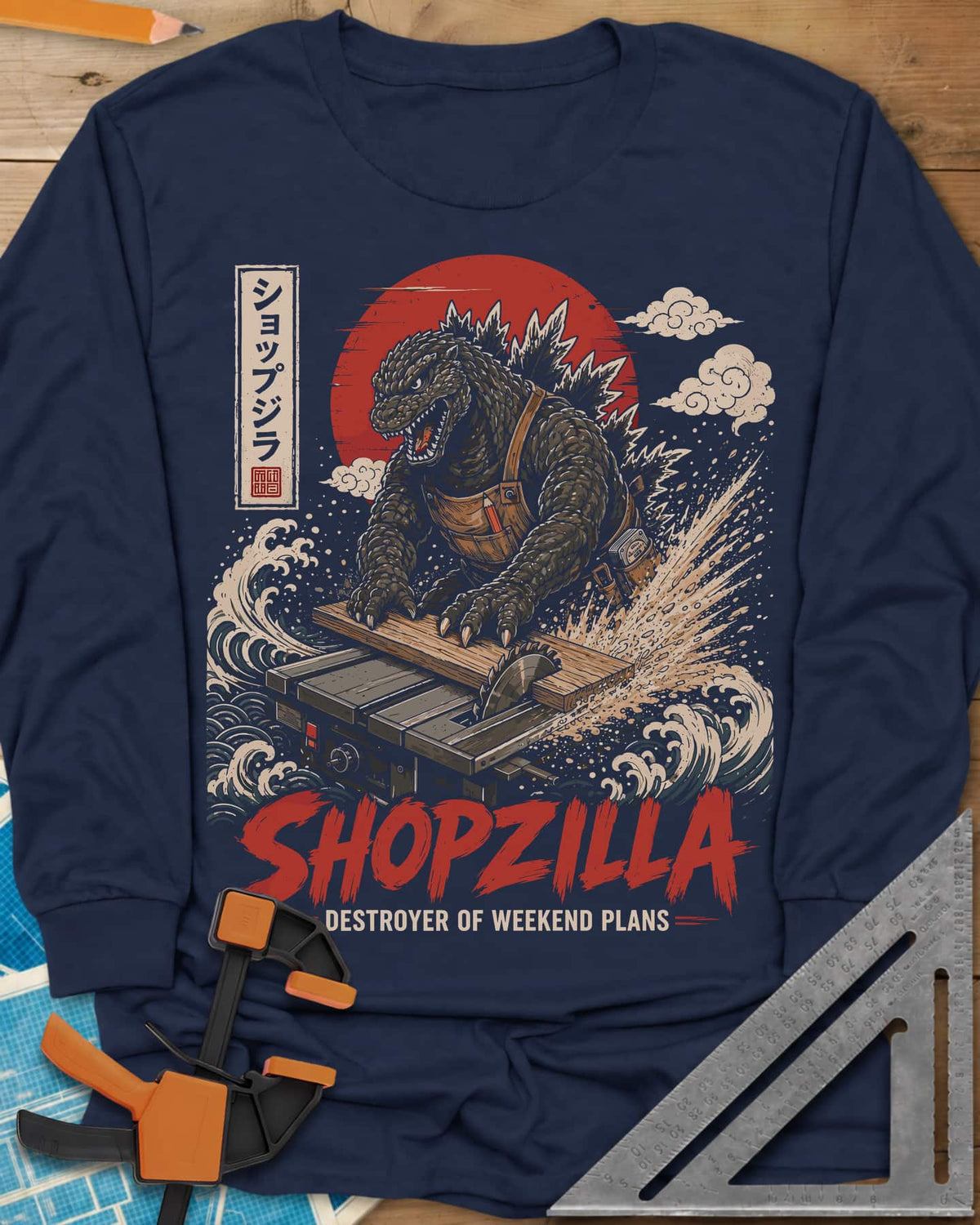 Shopzilla long sleeve shirt in Navy, a monster in a tool apron pushing a board through a table saw