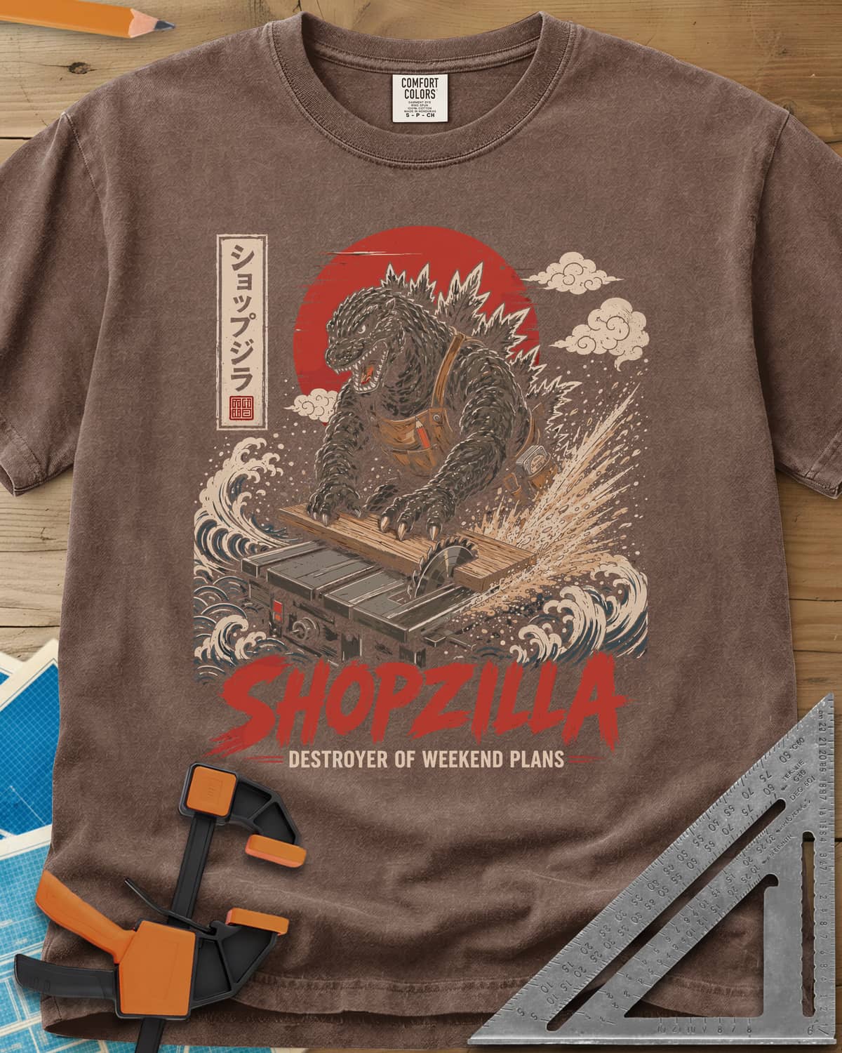 Shopzilla heavyweight tee in Espresso, a monster in a tool apron pushing a board through a table saw