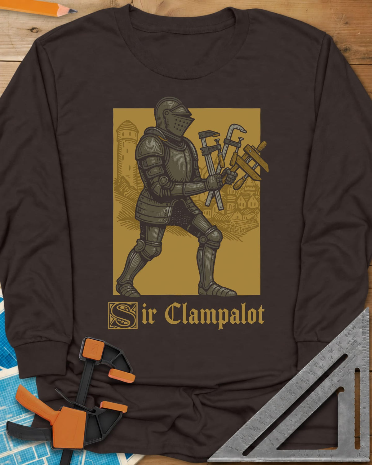 Sir Clampalot long sleeve shirt in Dark Chocolate, an armored knight carrying an armful of clamps