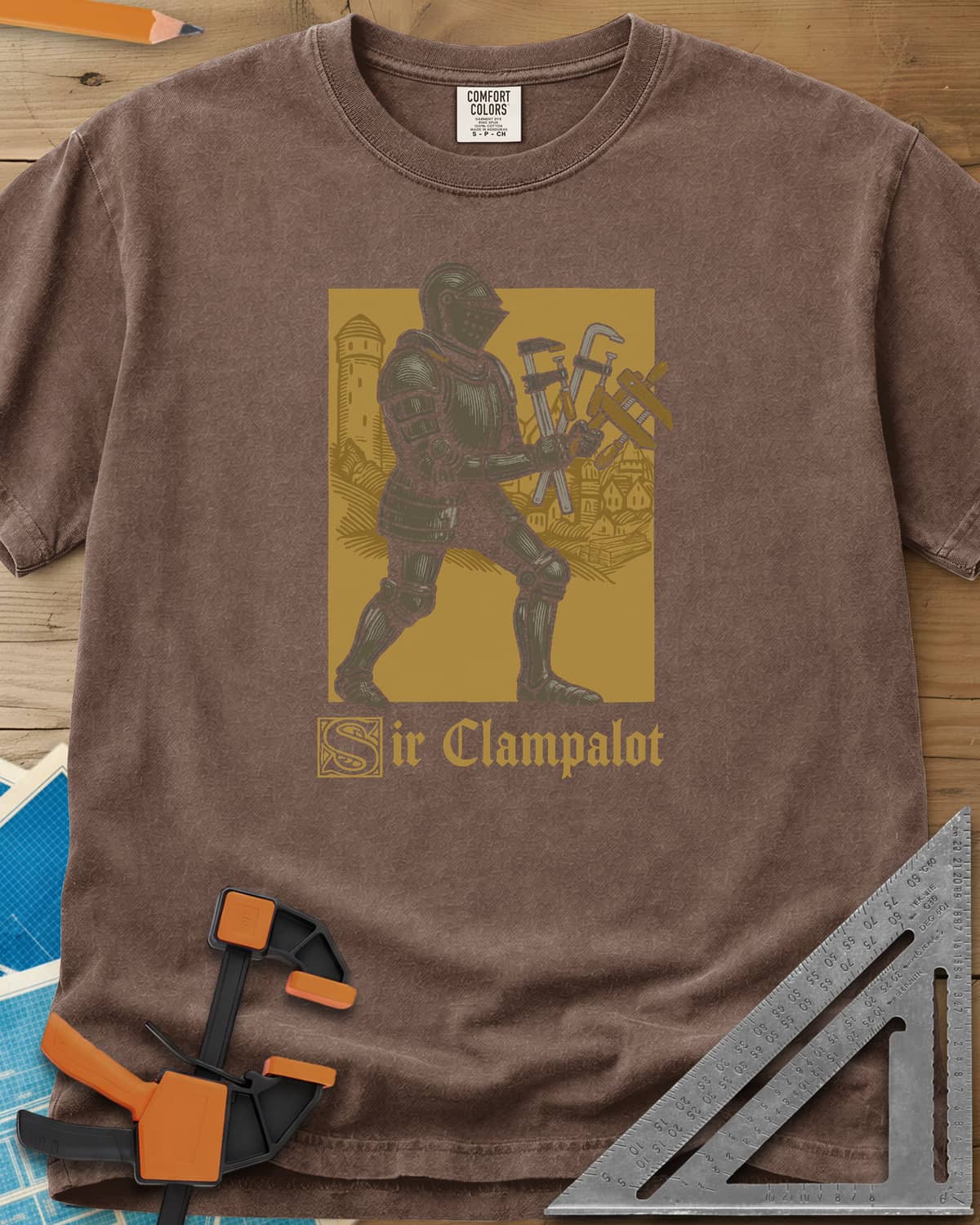 Sir Clampalot heavyweight tee in Espresso, an armored knight carrying an armful of clamps