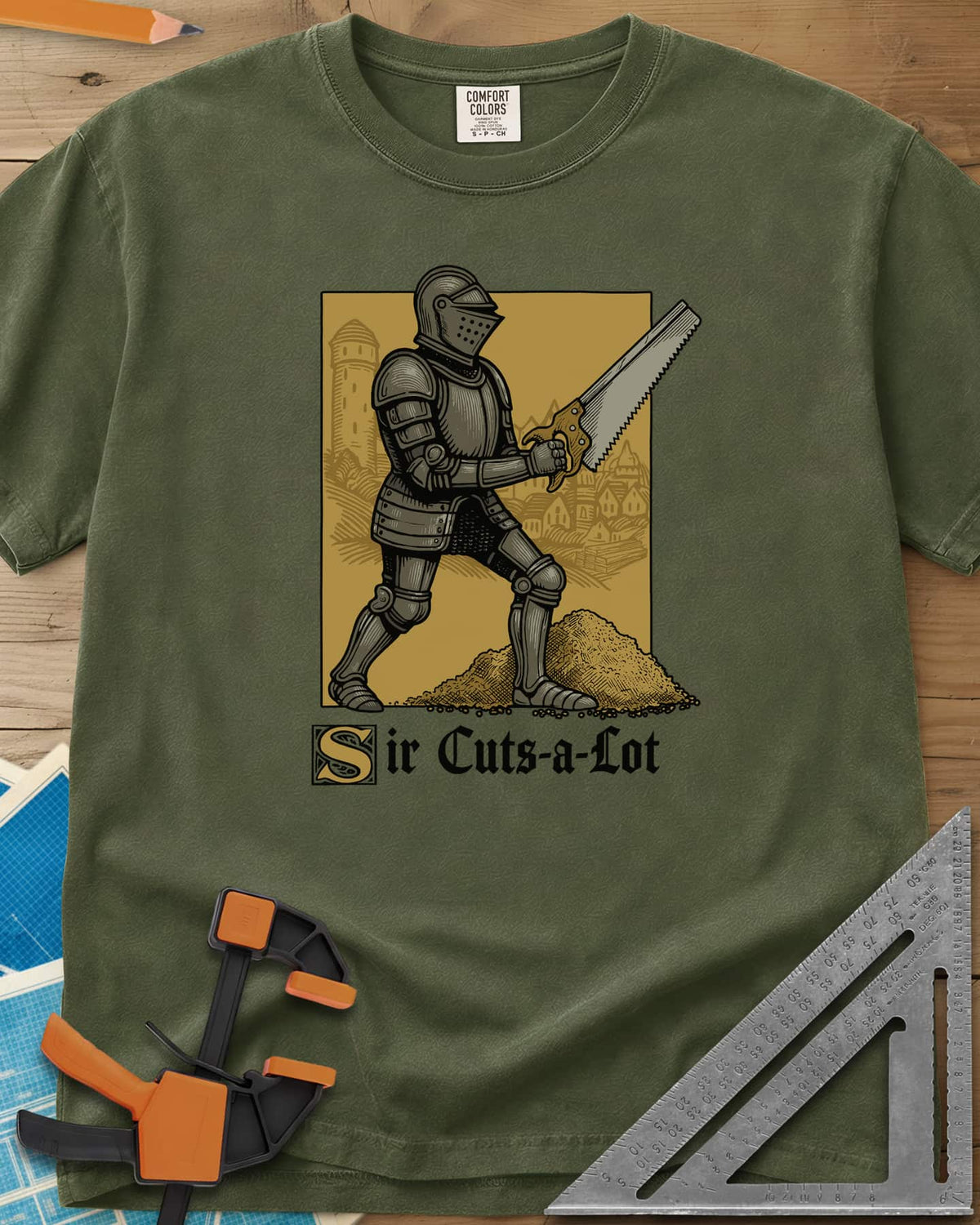 Sir Cuts A Lot heavyweight tee in Hemp, an armored knight with a handsaw and a mound of sawdust