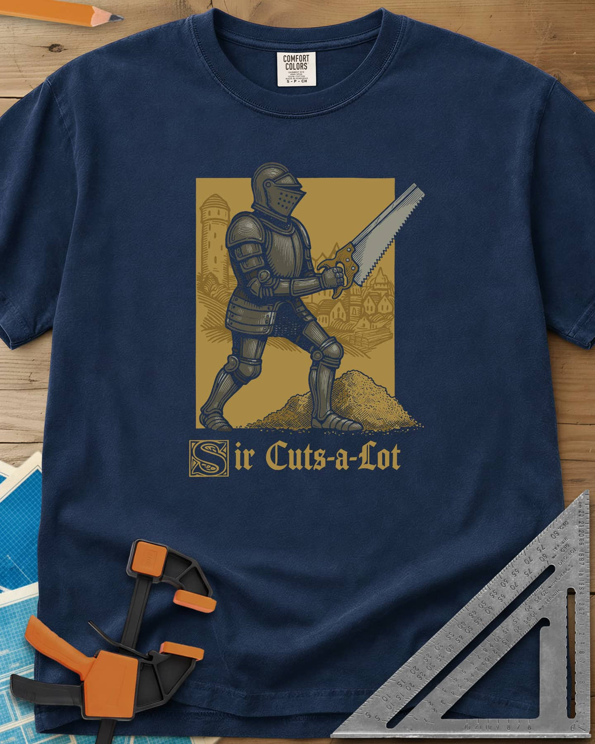 Sir Cuts A Lot heavyweight tee in Navy, an armored knight with a handsaw and a mound of sawdust