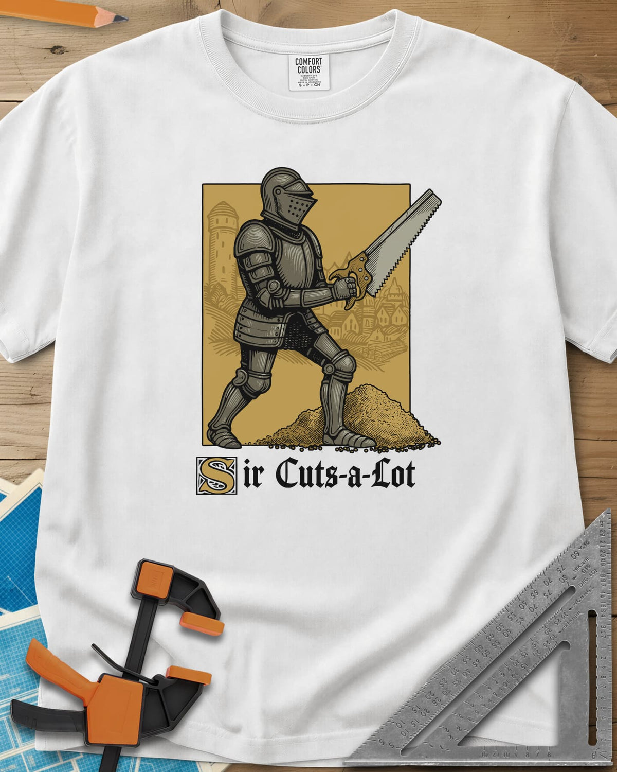 Sir Cuts A Lot heavyweight tee in White, an armored knight with a handsaw and a mound of sawdust
