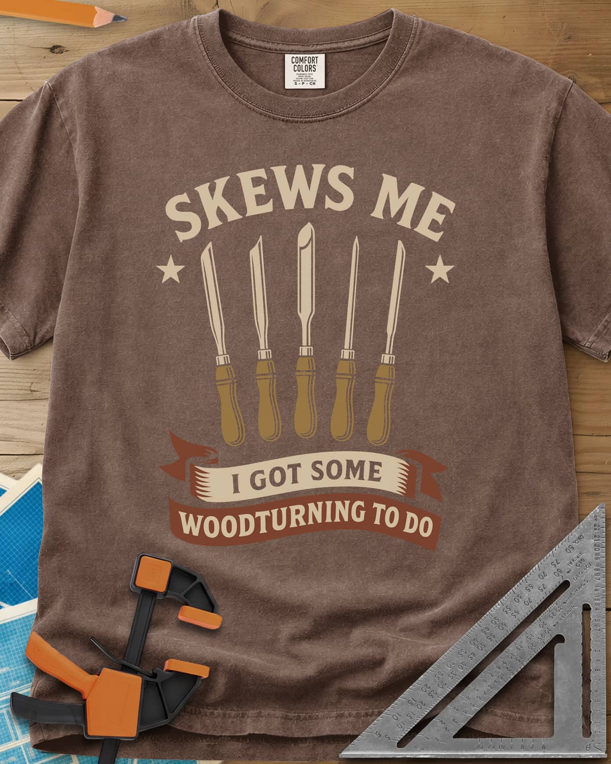 Skews Me heavyweight tee in Espresso, five turning tools between two stars above a ribbon banner