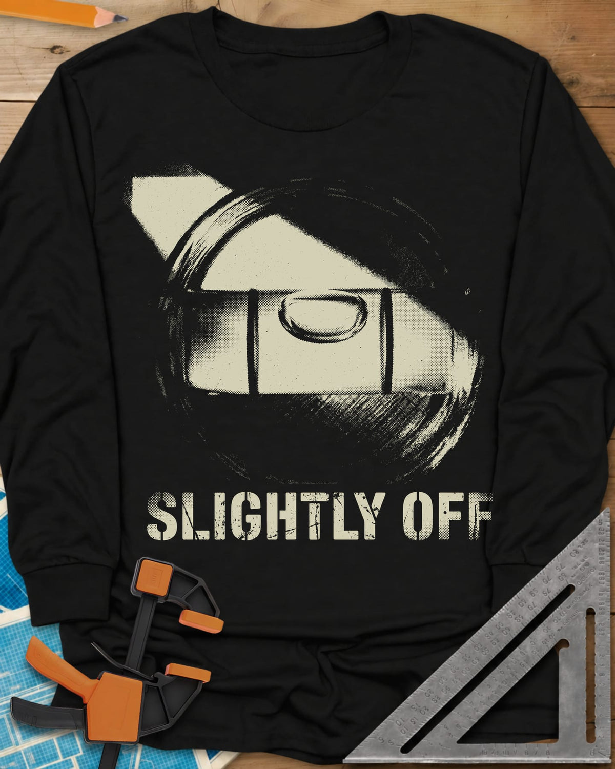 Slightly Off Level long sleeve shirt in Black, a tilted spirit level and its bubble vial in grainy halftone