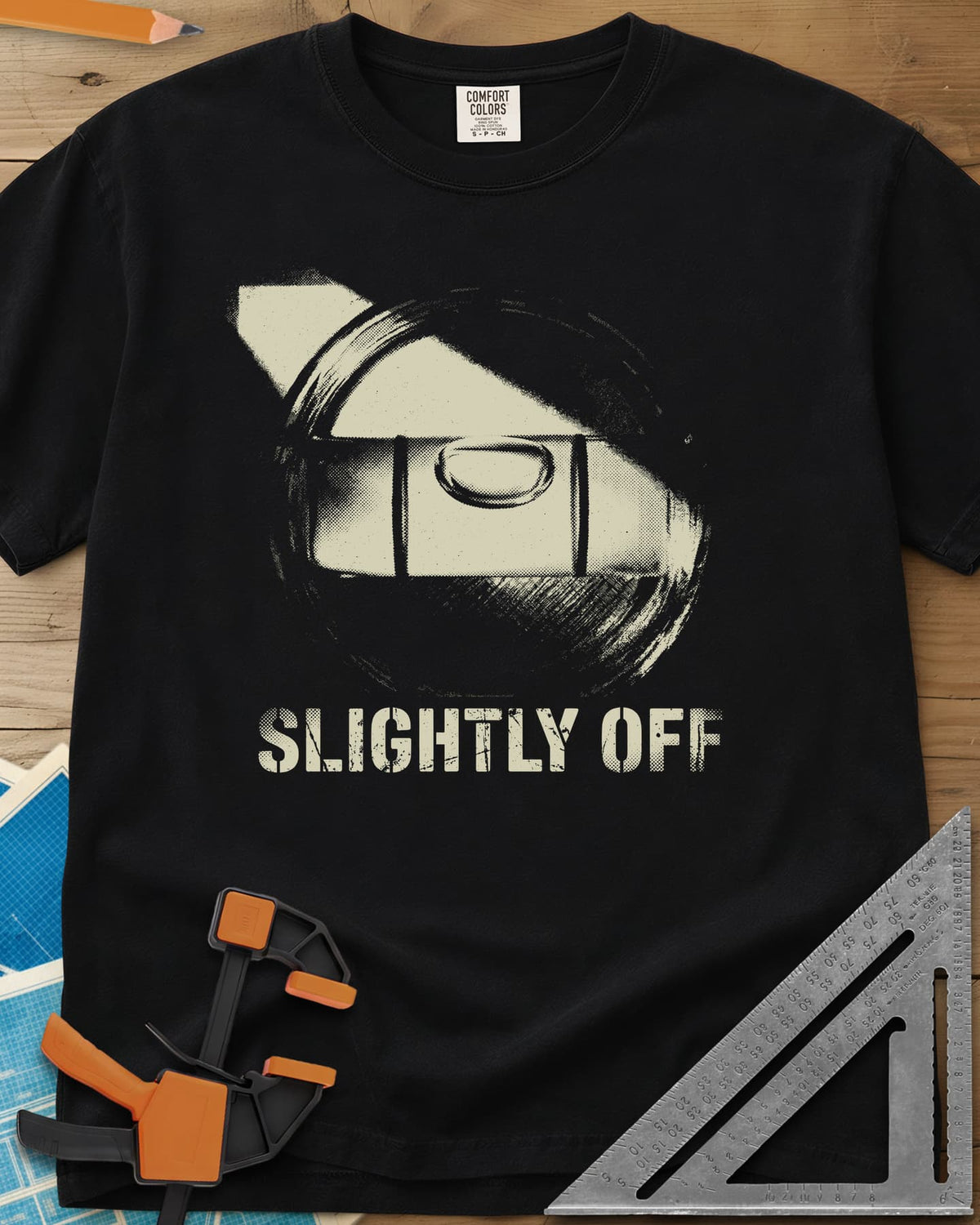 Slightly Off Level heavyweight tee in Black, a tilted spirit level and its bubble vial in grainy halftone