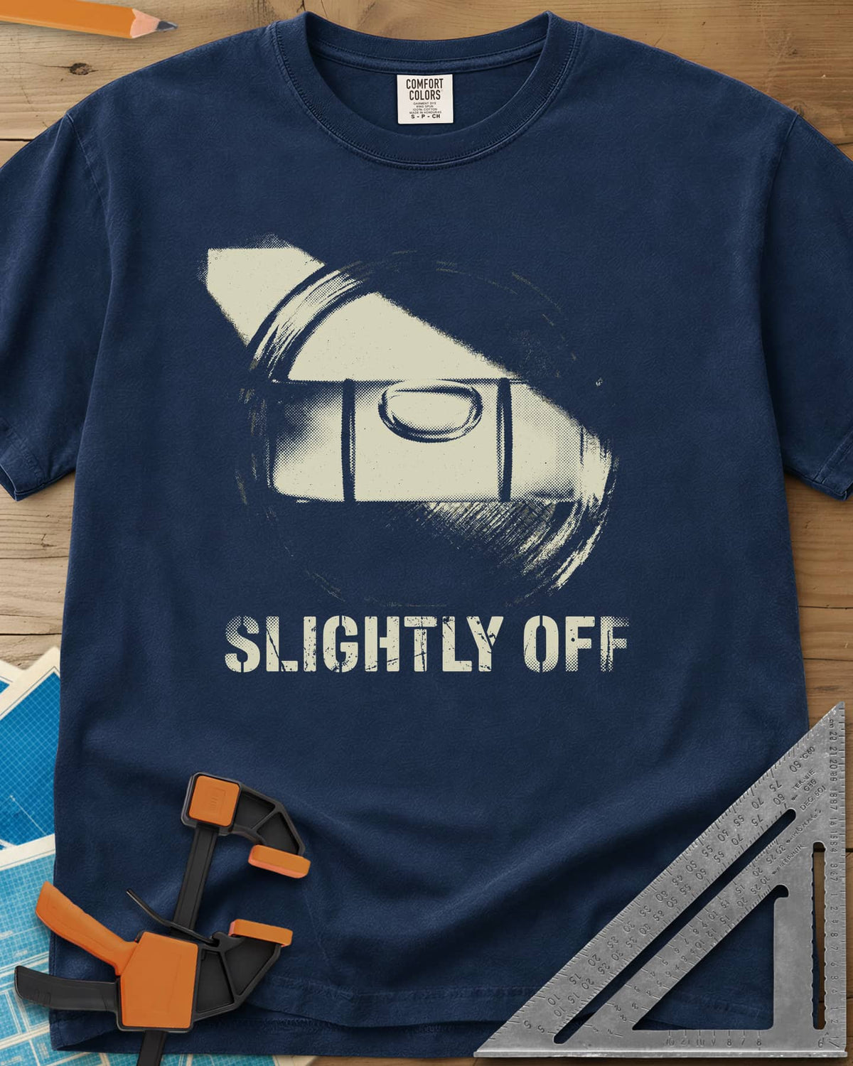 Slightly Off Level heavyweight tee in Navy, a tilted spirit level and its bubble vial in grainy halftone