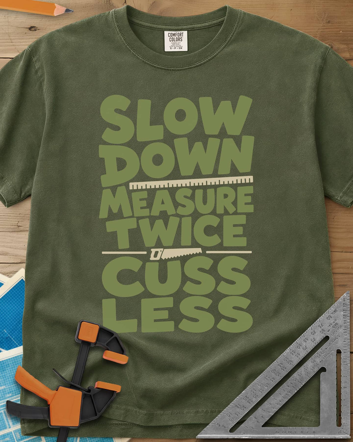 Slow Down Measure Twice heavyweight tee in Hemp, stacked green letters with a ruler and a small handsaw between lines