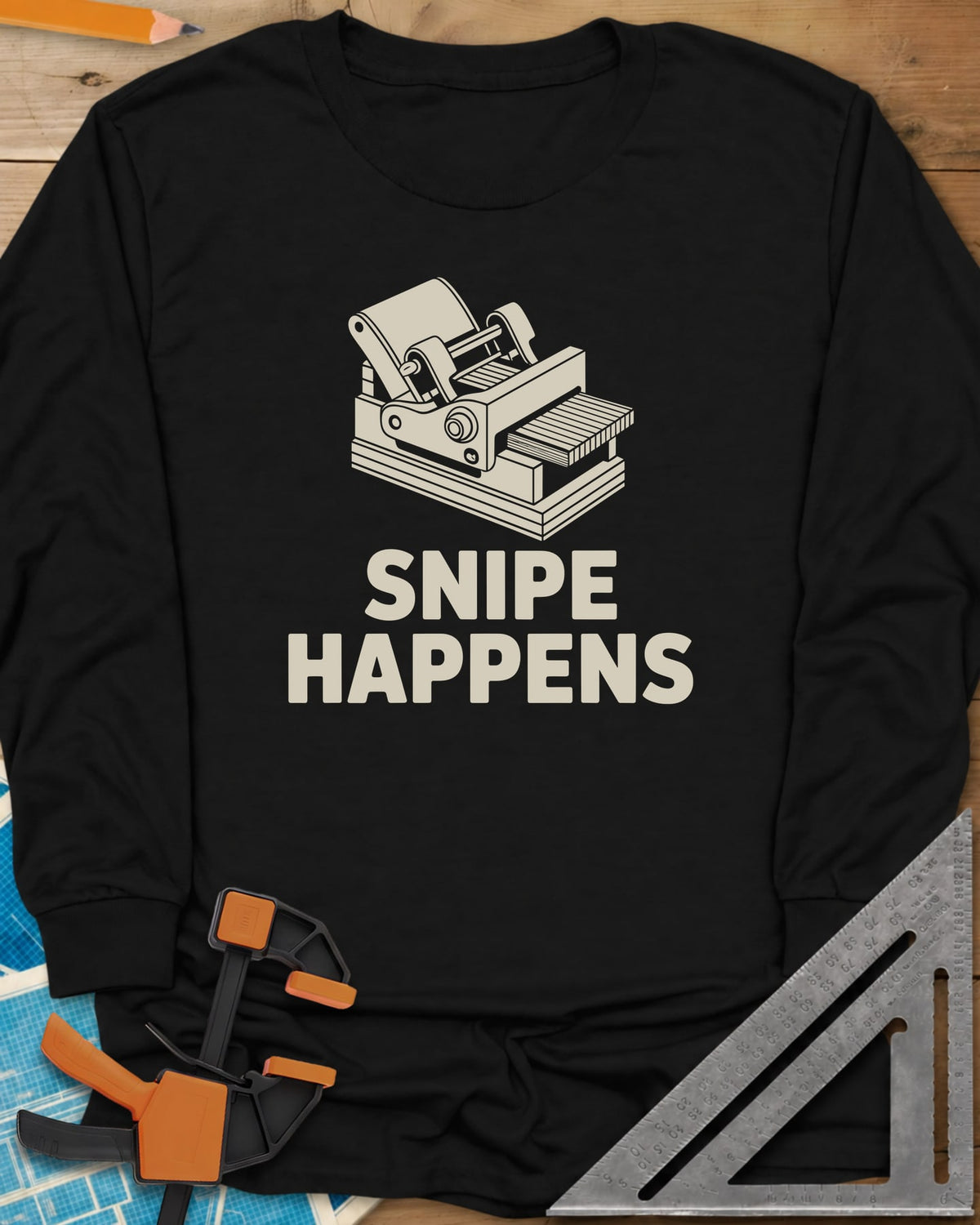 Snipe Happens long sleeve shirt in Black, a thickness planer line drawing with boards at the outfeed