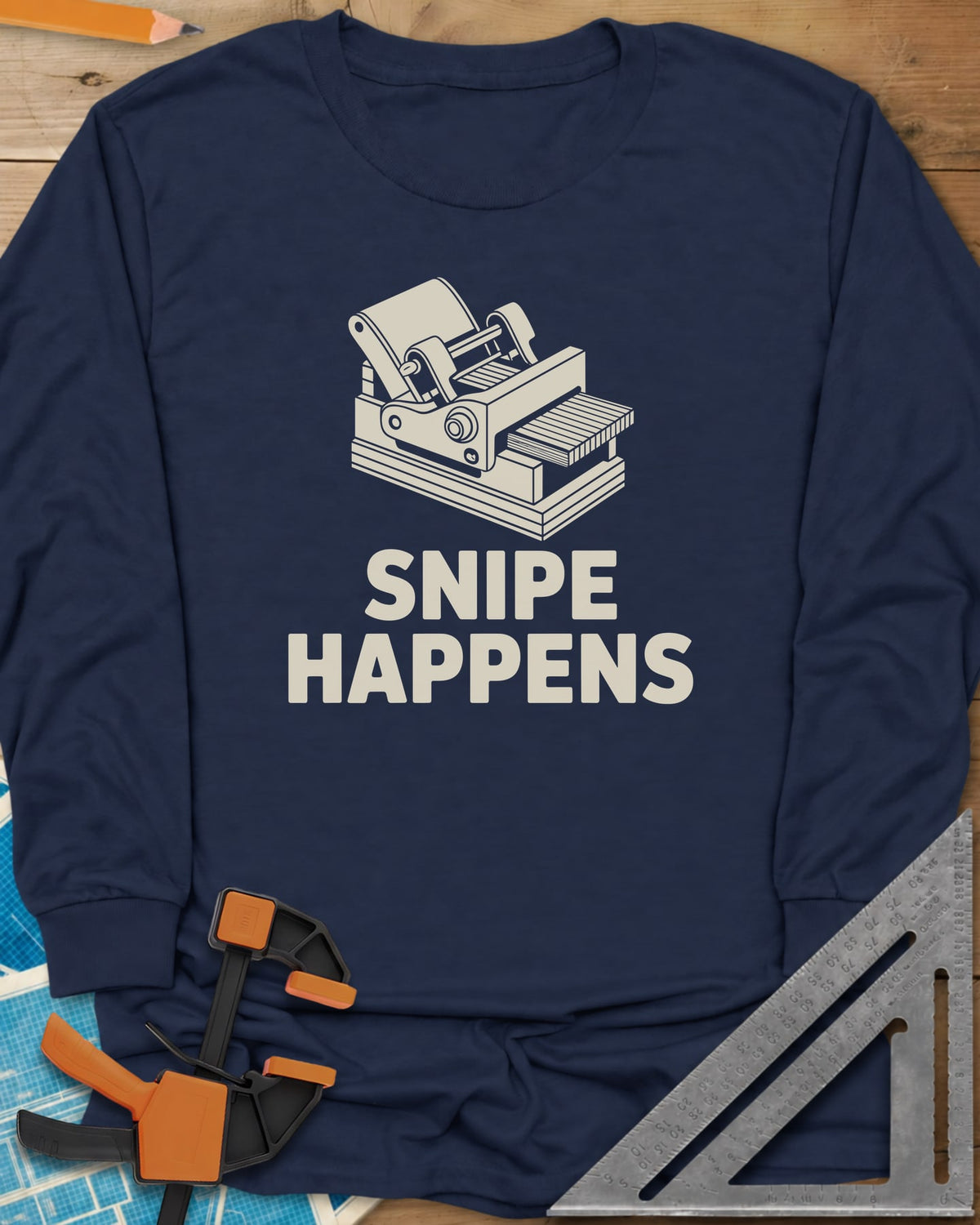 Snipe Happens long sleeve shirt in Navy, a thickness planer line drawing with boards at the outfeed
