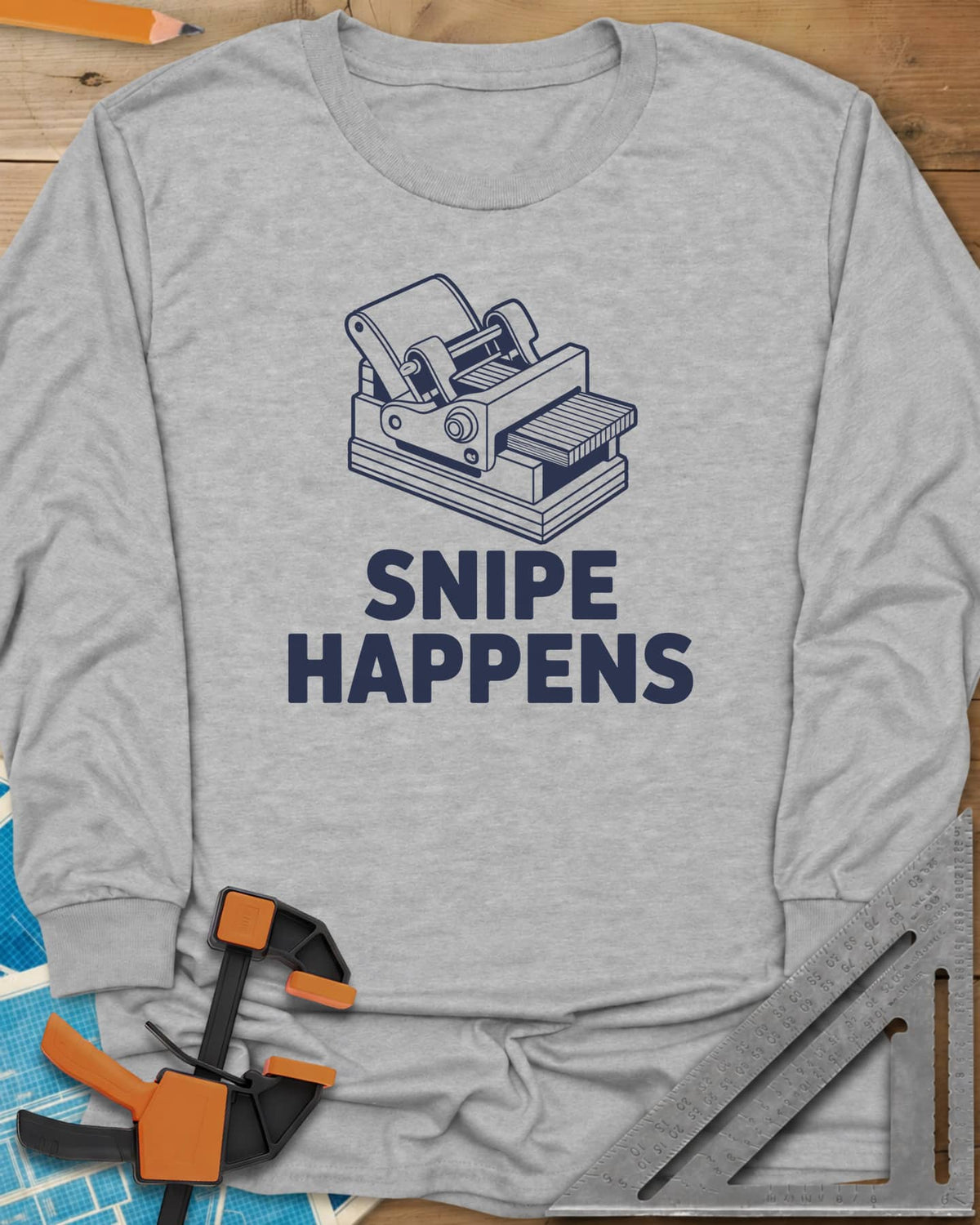 Snipe Happens long sleeve shirt in Sport Grey, a thickness planer line drawing with boards at the outfeed