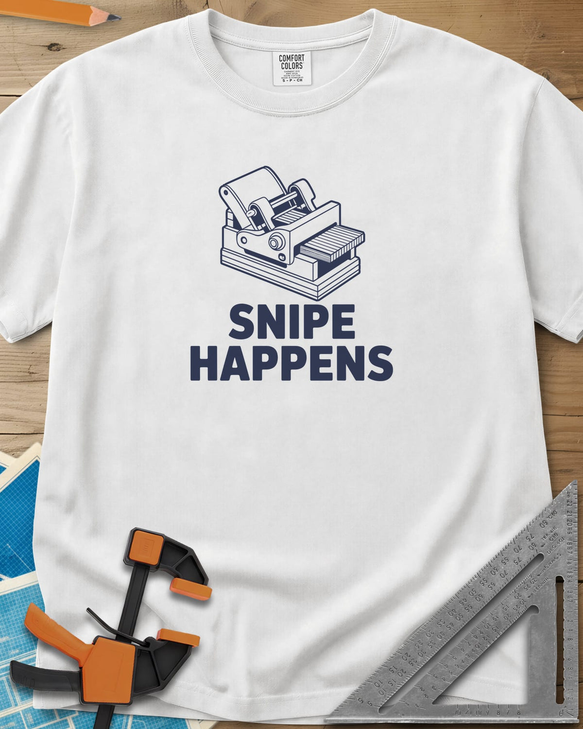 Snipe Happens heavyweight tee in White, a thickness planer line drawing with boards at the outfeed
