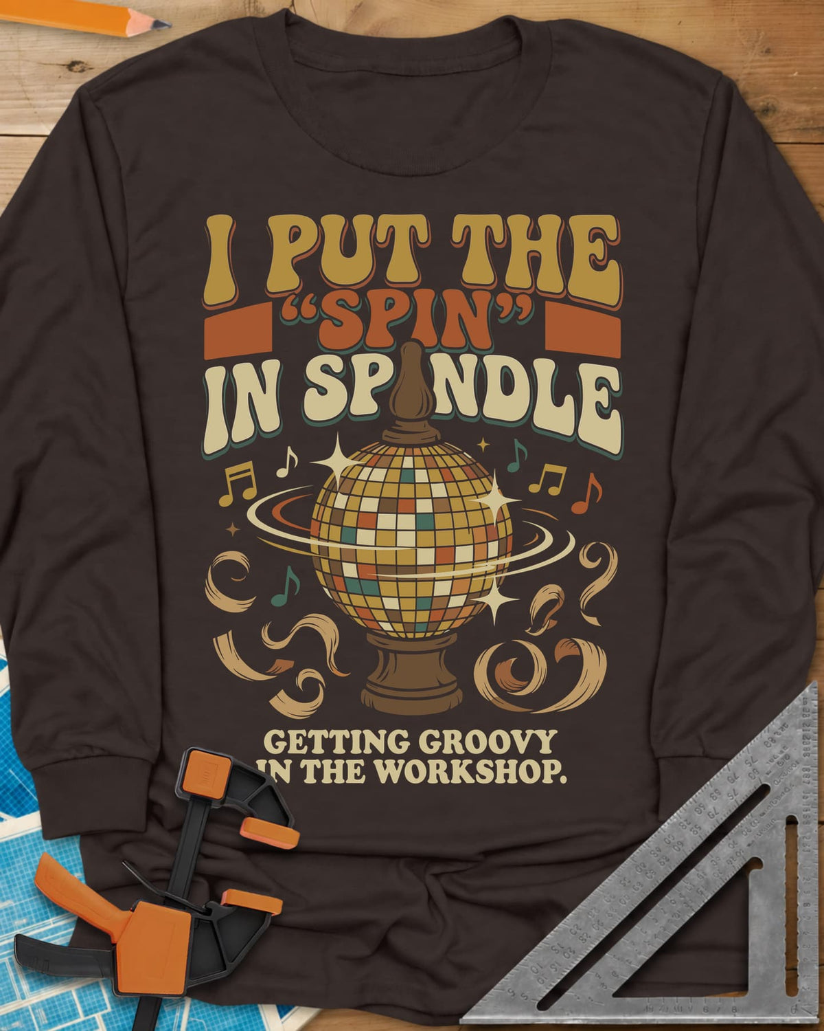 Spin in Spindle long sleeve shirt in Dark Chocolate, a disco ball on a turned wooden base with notes and shavings