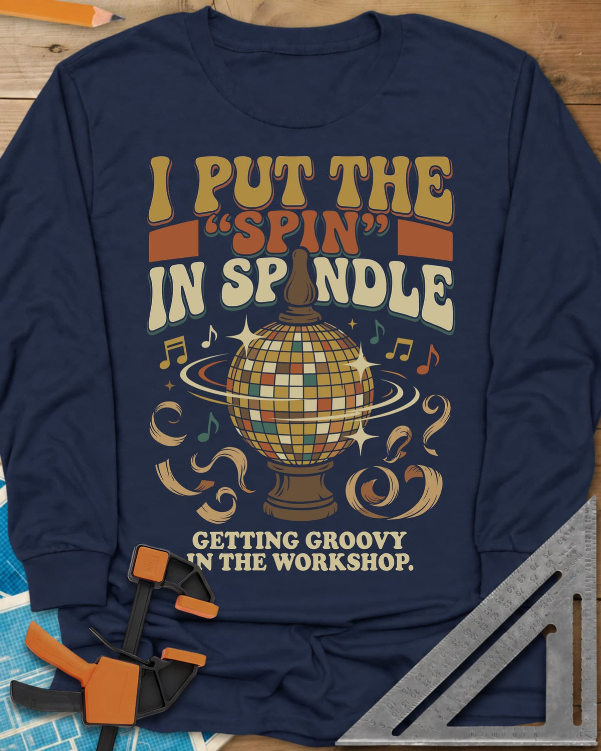 Spin in Spindle long sleeve shirt in Navy, a disco ball on a turned wooden base with notes and shavings