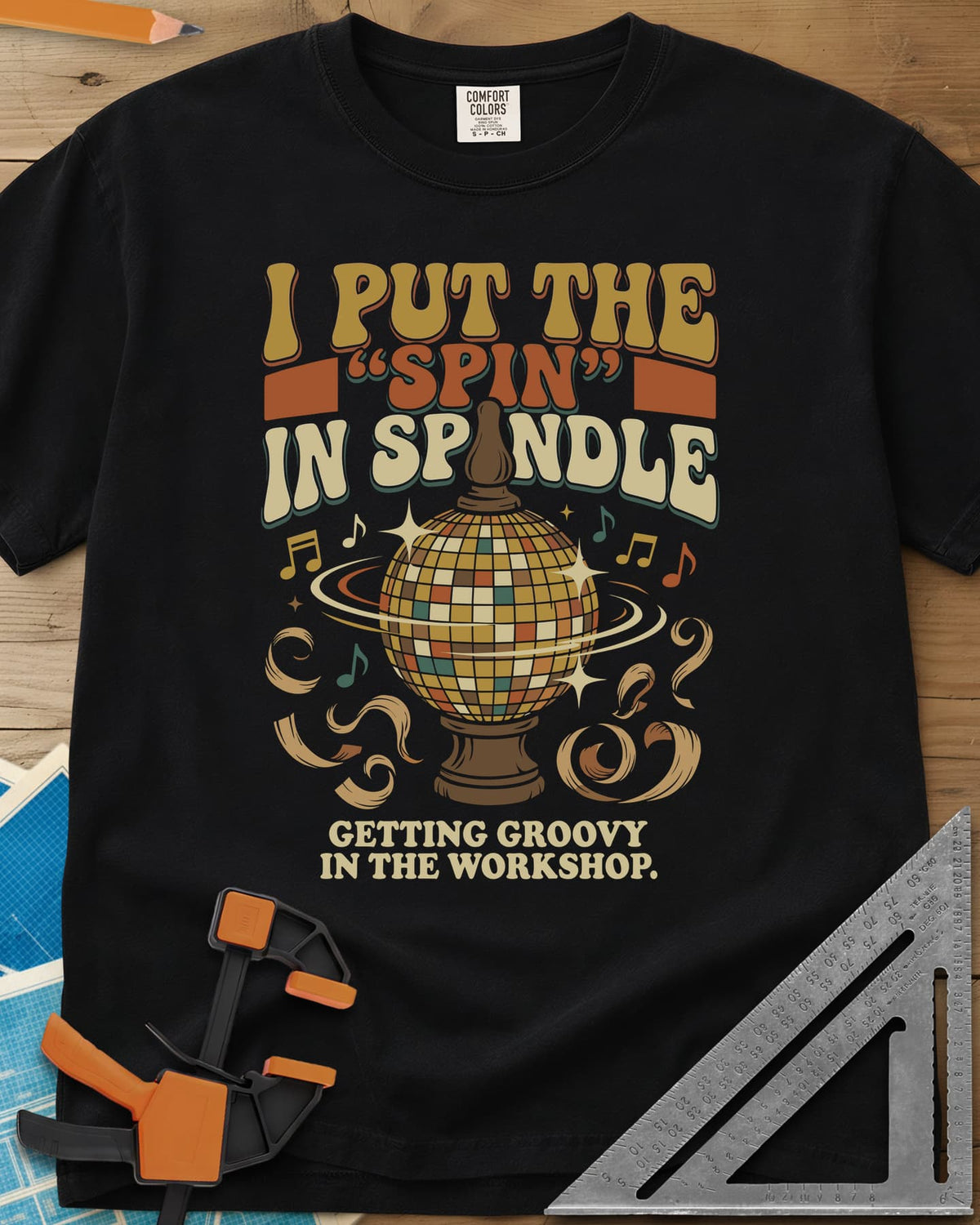 Spin in Spindle heavyweight tee in Black, a disco ball on a turned wooden base with notes and shavings