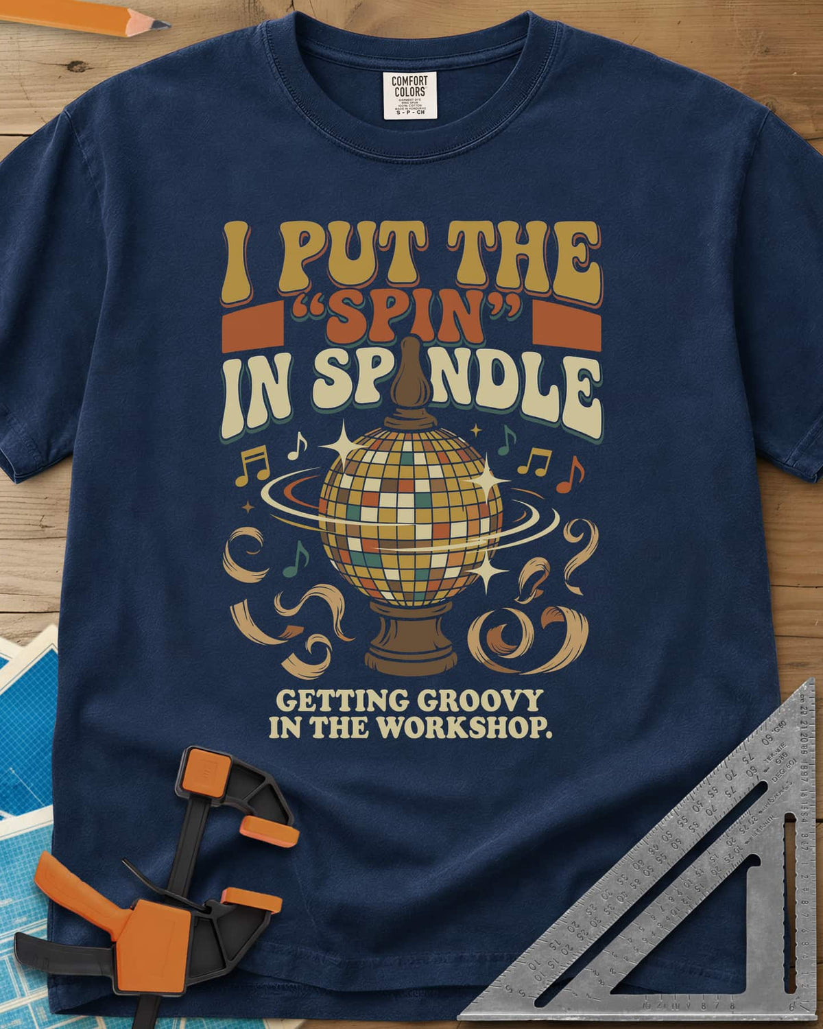 Spin in Spindle heavyweight tee in Navy, a disco ball on a turned wooden base with notes and shavings