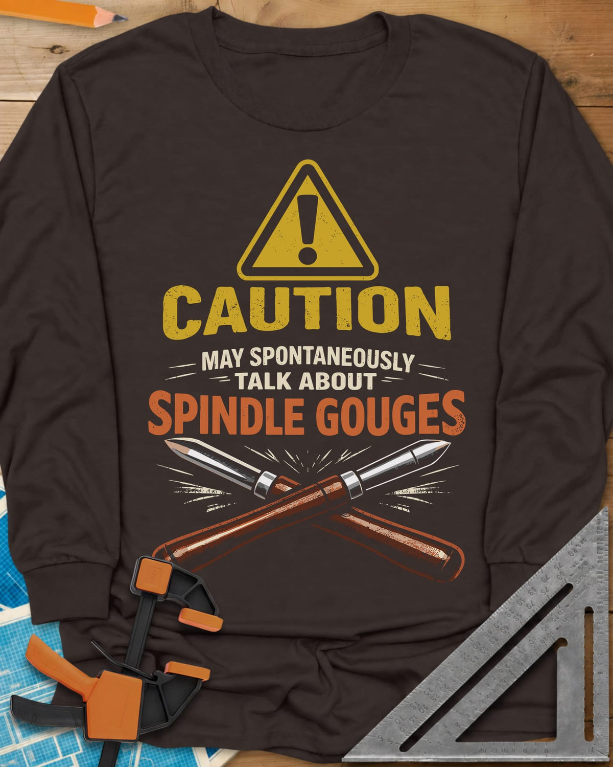 Spindle Gouges long sleeve shirt in Dark Chocolate, a hazard triangle above two crossed spindle gouges