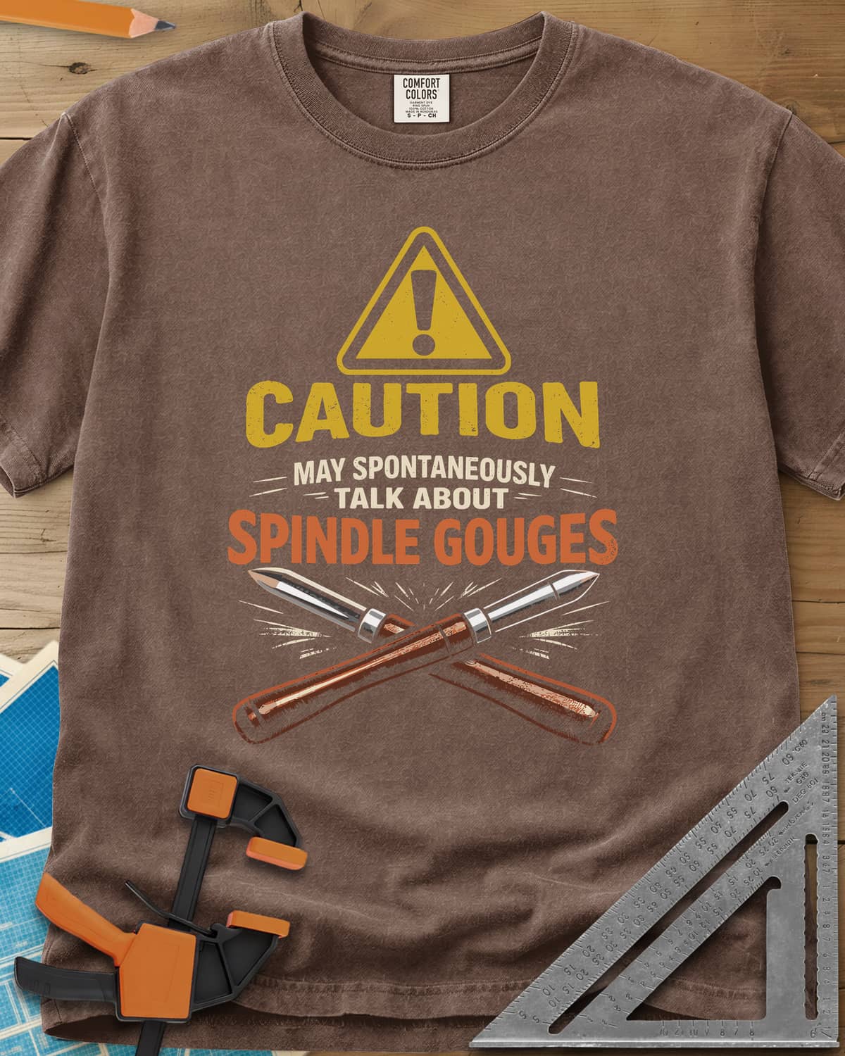 Spindle Gouges heavyweight tee in Espresso, a hazard triangle above two crossed spindle gouges