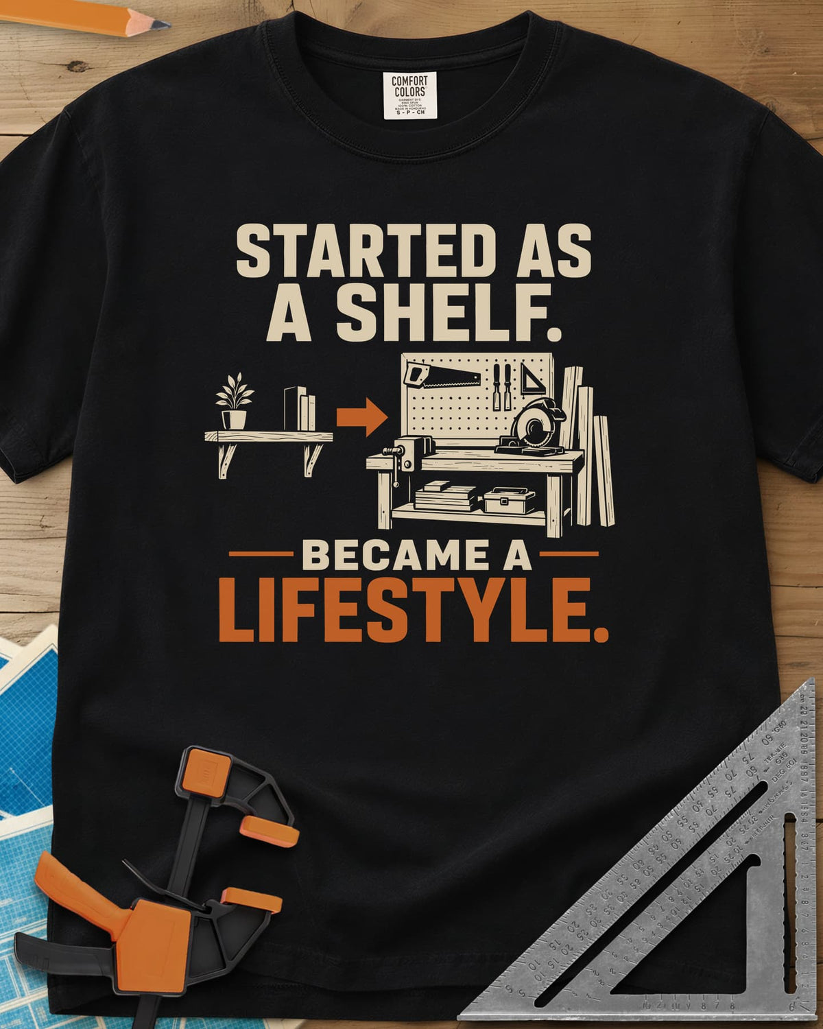 Started As A Shelf heavyweight tee in Black, a plant shelf, an arrow, then a workbench with pegboard and vise