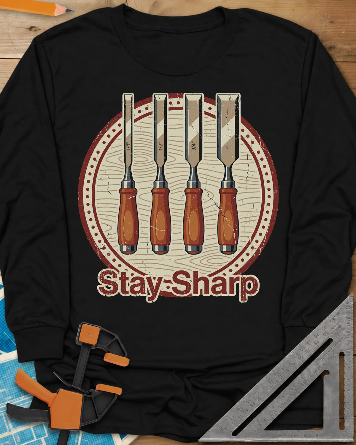 Stay Sharp long sleeve shirt in Black, four wood chisels on a round wood-grain badge