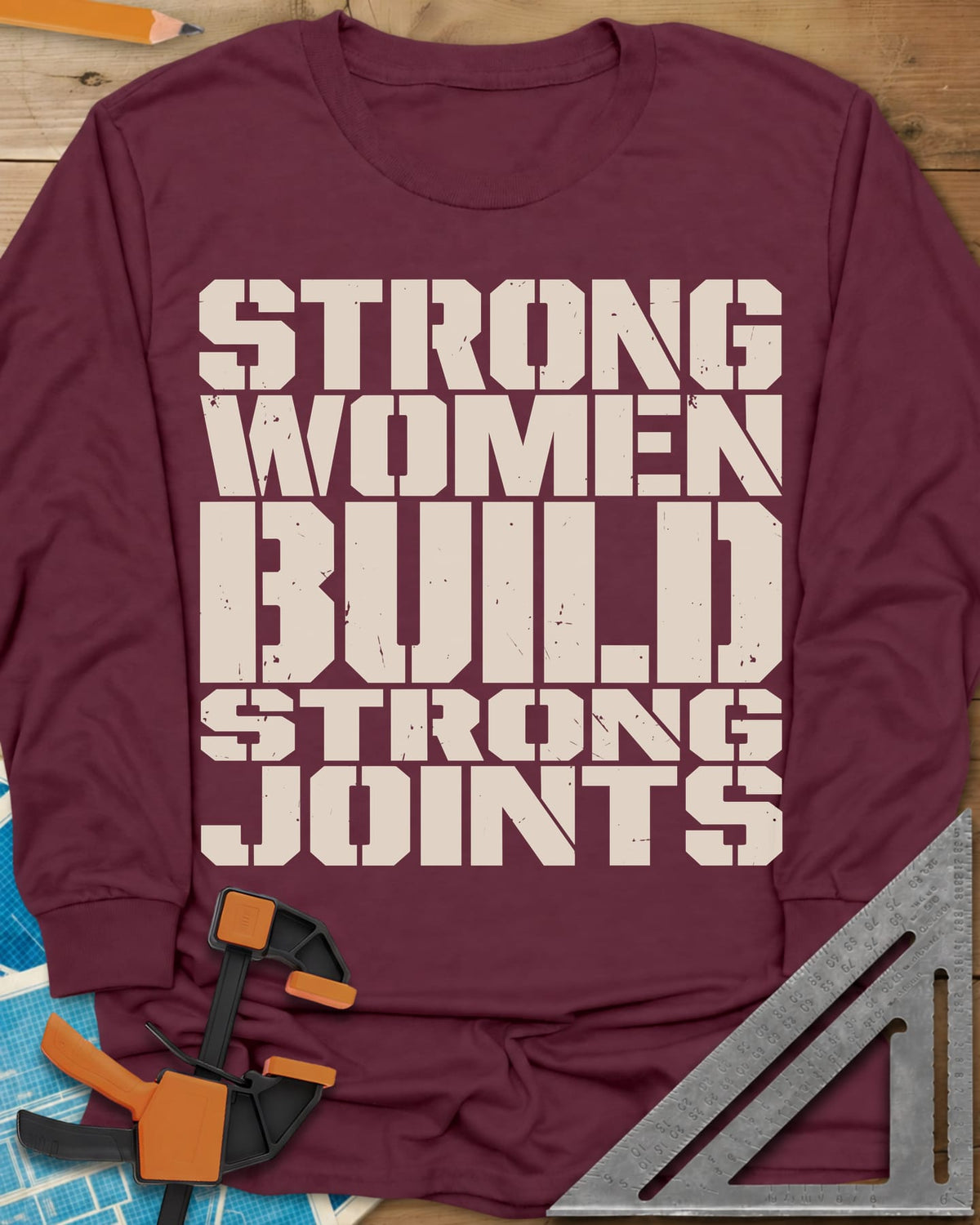 Strong Women long sleeve shirt in Maroon, five lines of stacked, worn stencil capitals