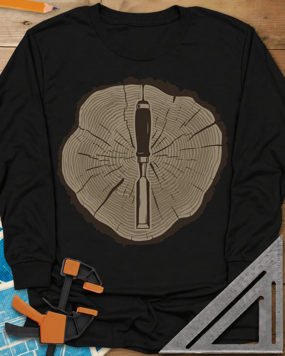 Stump & Chisel long sleeve shirt in Black, a wood chisel set in the middle of a cracked tree-ring slice
