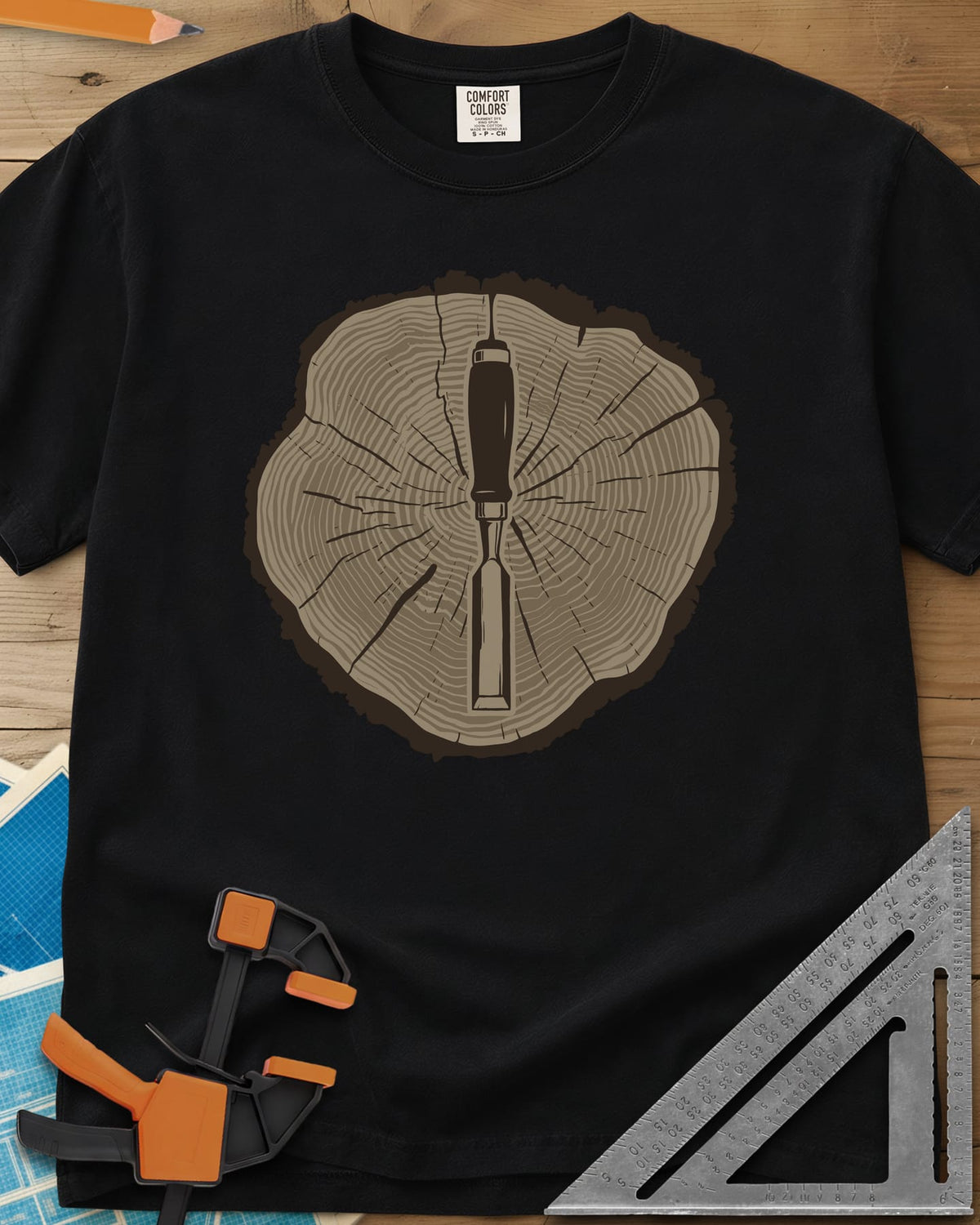 Stump & Chisel heavyweight tee in Black, a wood chisel set in the middle of a cracked tree-ring slice