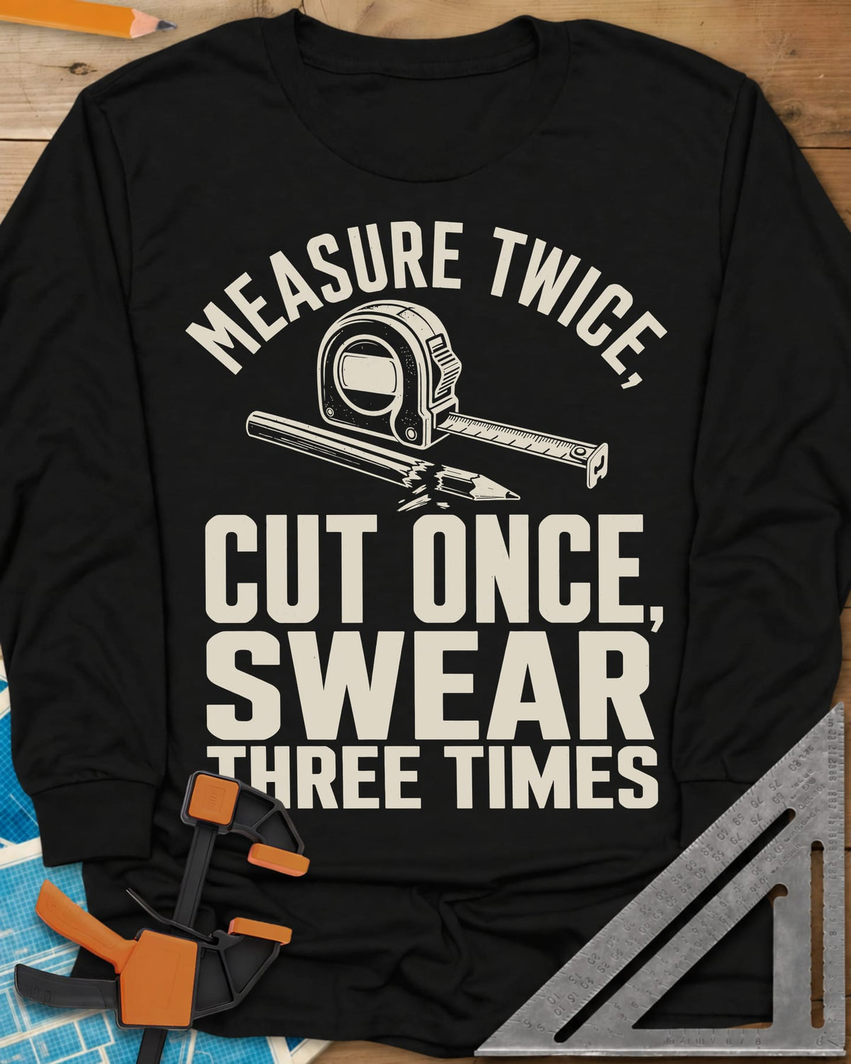 Swear Three Times long sleeve shirt in Black, a tape measure and a pencil with a broken tip