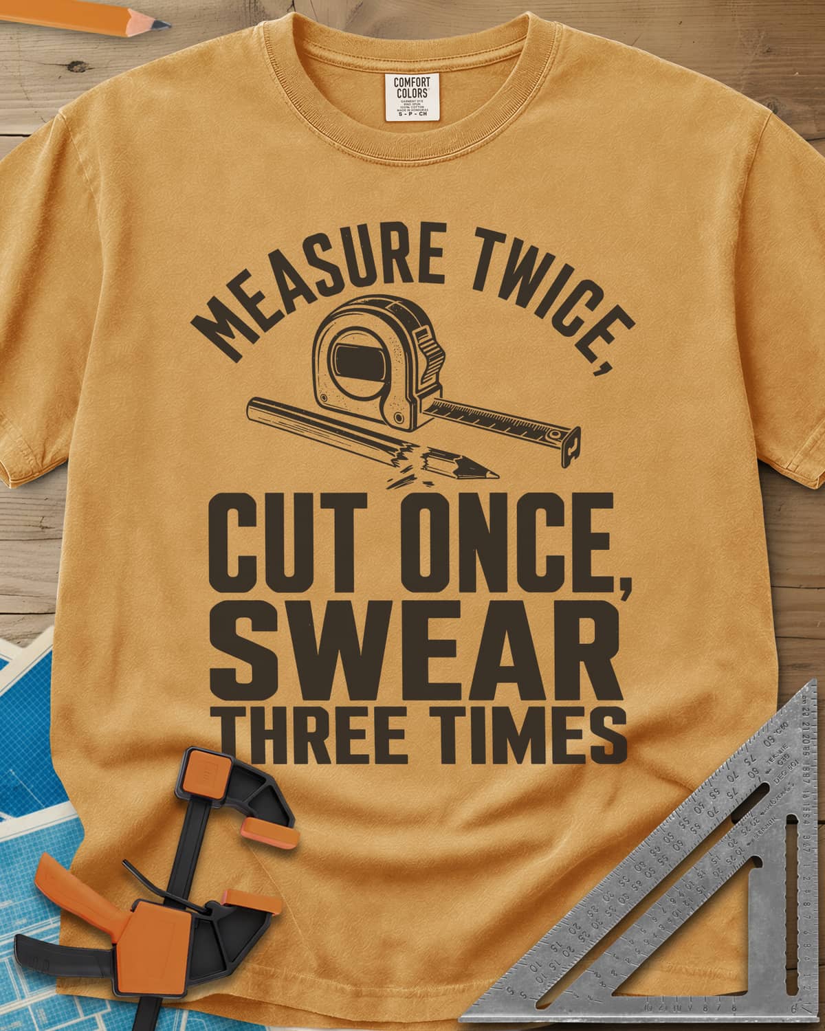 Swear Three Times heavyweight tee in Mustard, a tape measure and a pencil with a broken tip