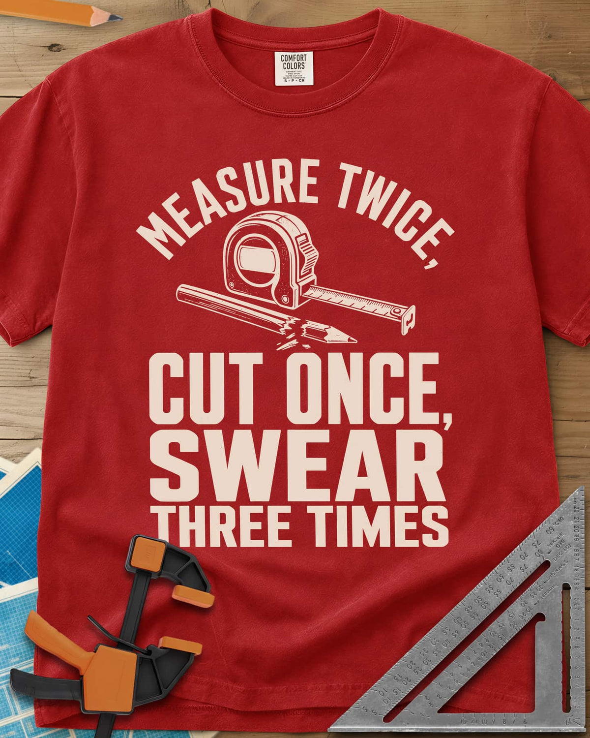 Swear Three Times heavyweight tee in Red, a tape measure and a pencil with a broken tip