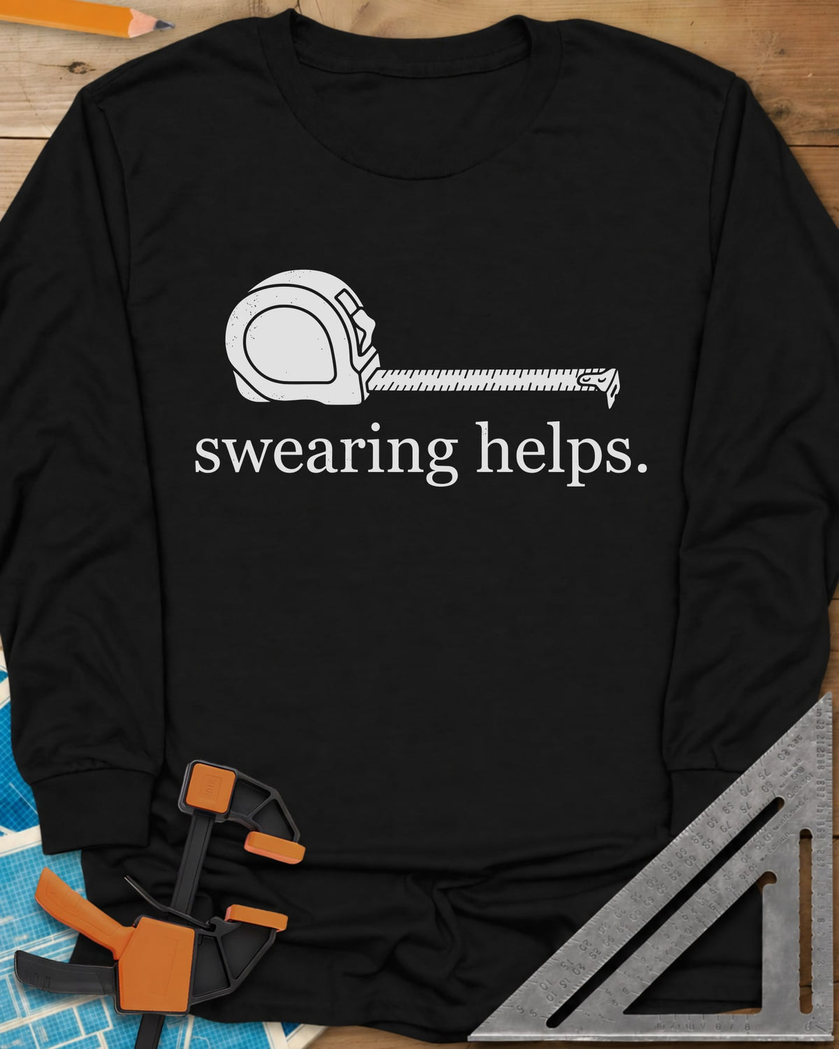 Swearing Helps long sleeve shirt in Black, a tape measure with its blade pulled out above small lowercase type