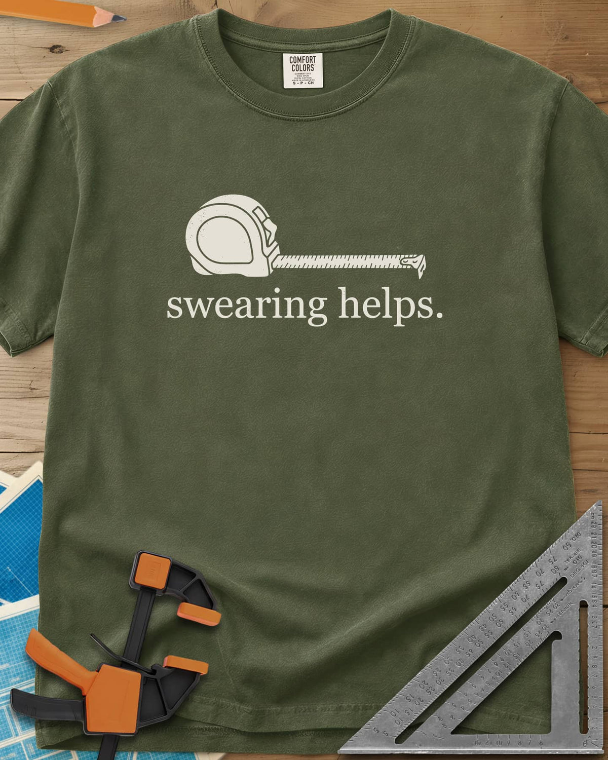 Swearing Helps heavyweight tee in Hemp, a tape measure with its blade pulled out above small lowercase type