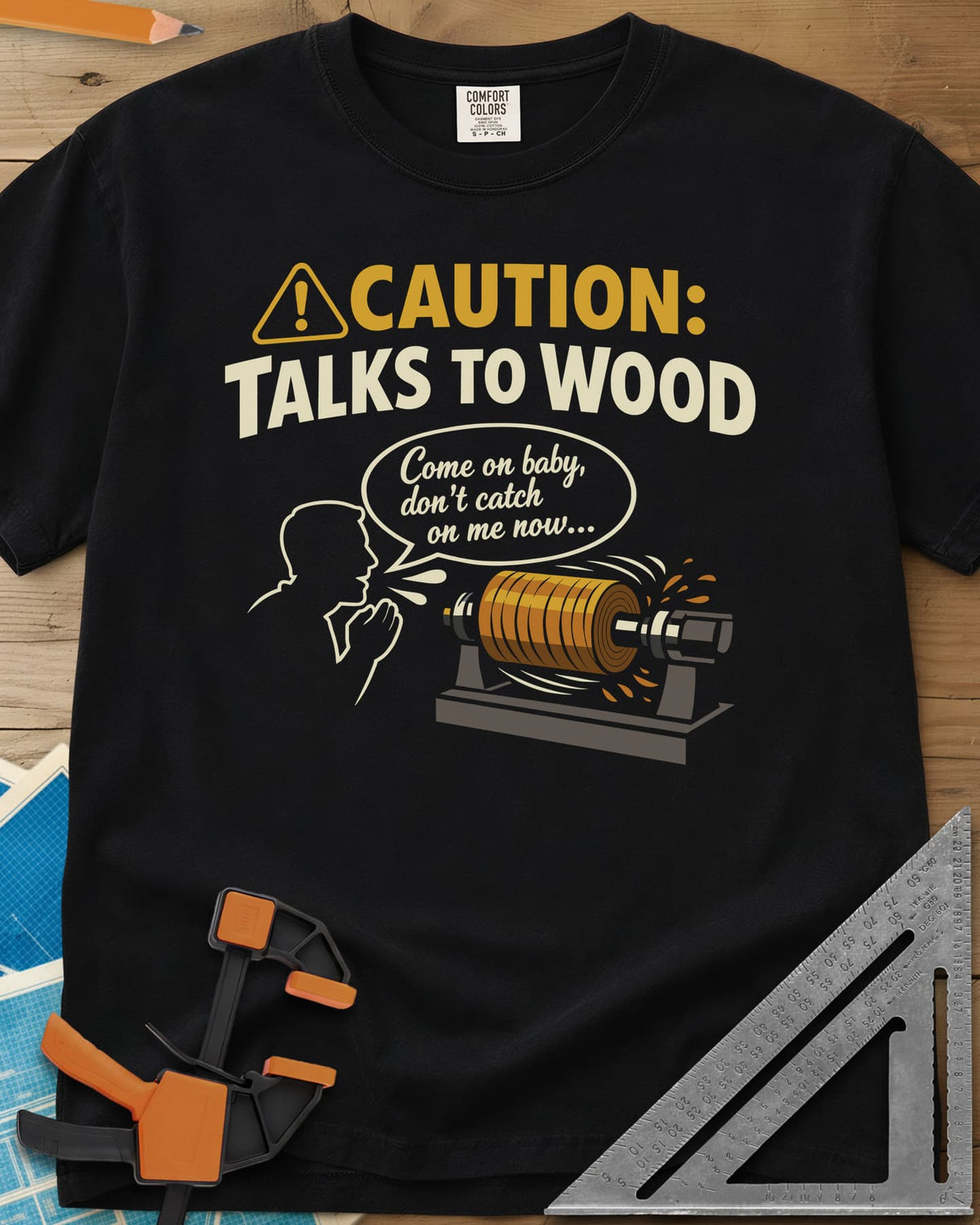 Talks to Wood heavyweight tee in Black, a man in outline coaxing a spinning wood blank on a lathe