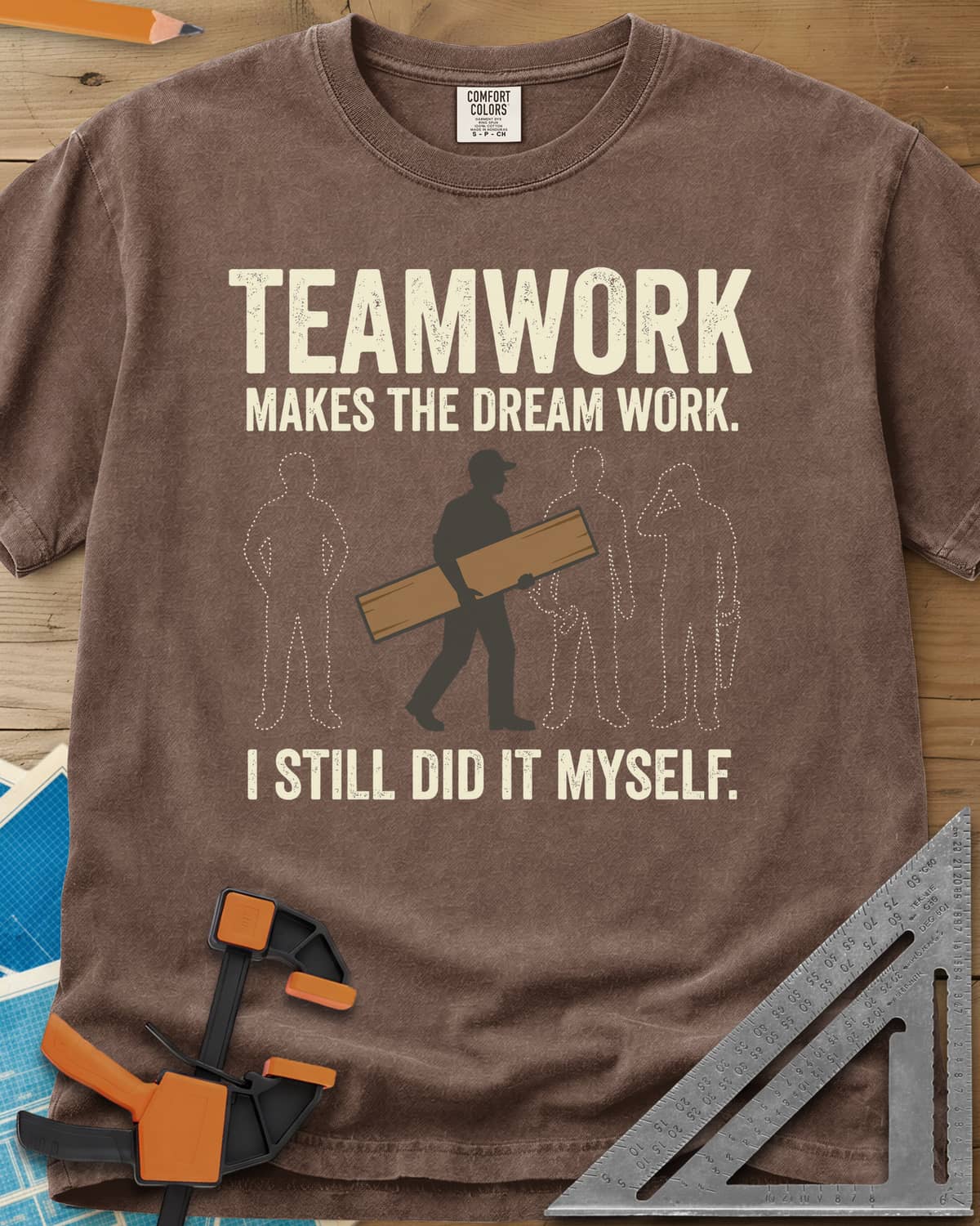 Teamwork I Did It Myself heavyweight tee in Espresso, a lone figure carrying a board past three dotted outlines