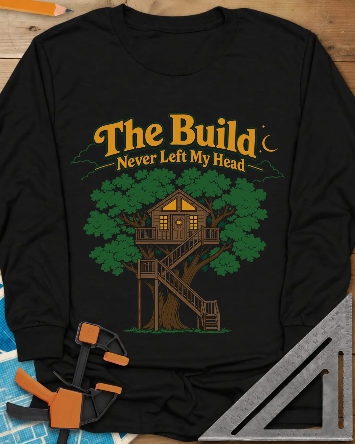 The Build Never Left My Head long sleeve shirt in Black, a glowing treehouse in a big oak under a crescent moon