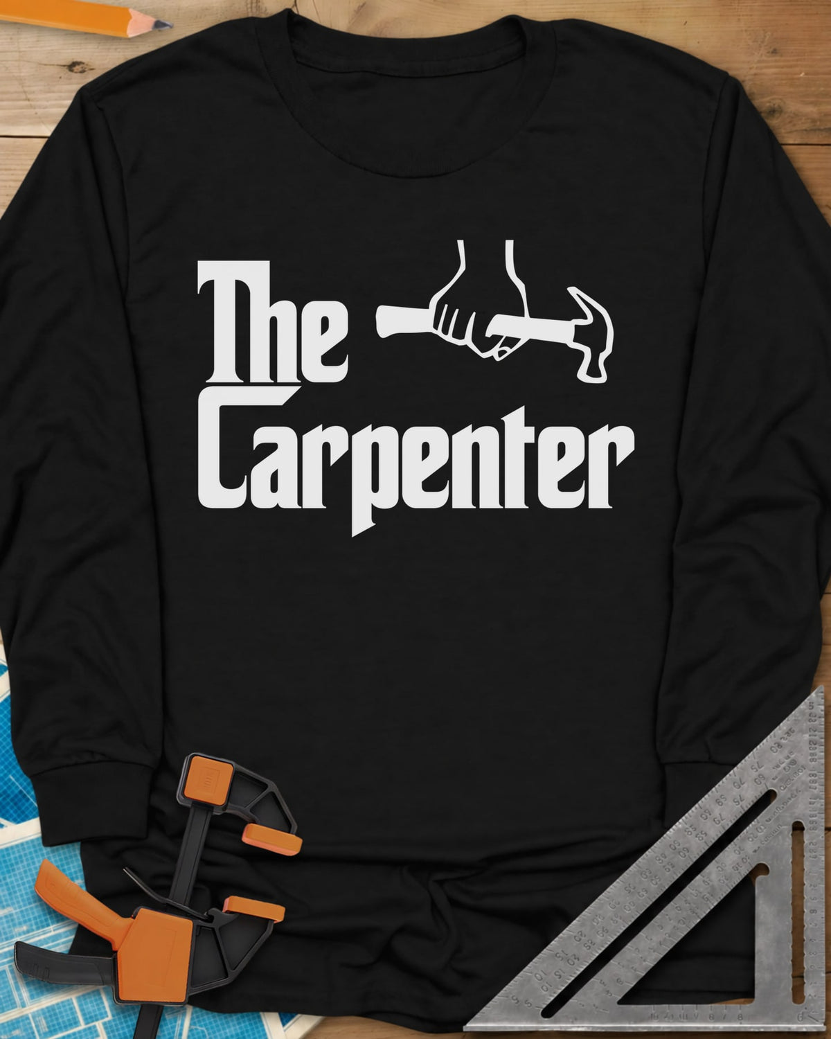 The Carpenter long sleeve shirt in Black, film-poster style lettering with a fist gripping a hammer