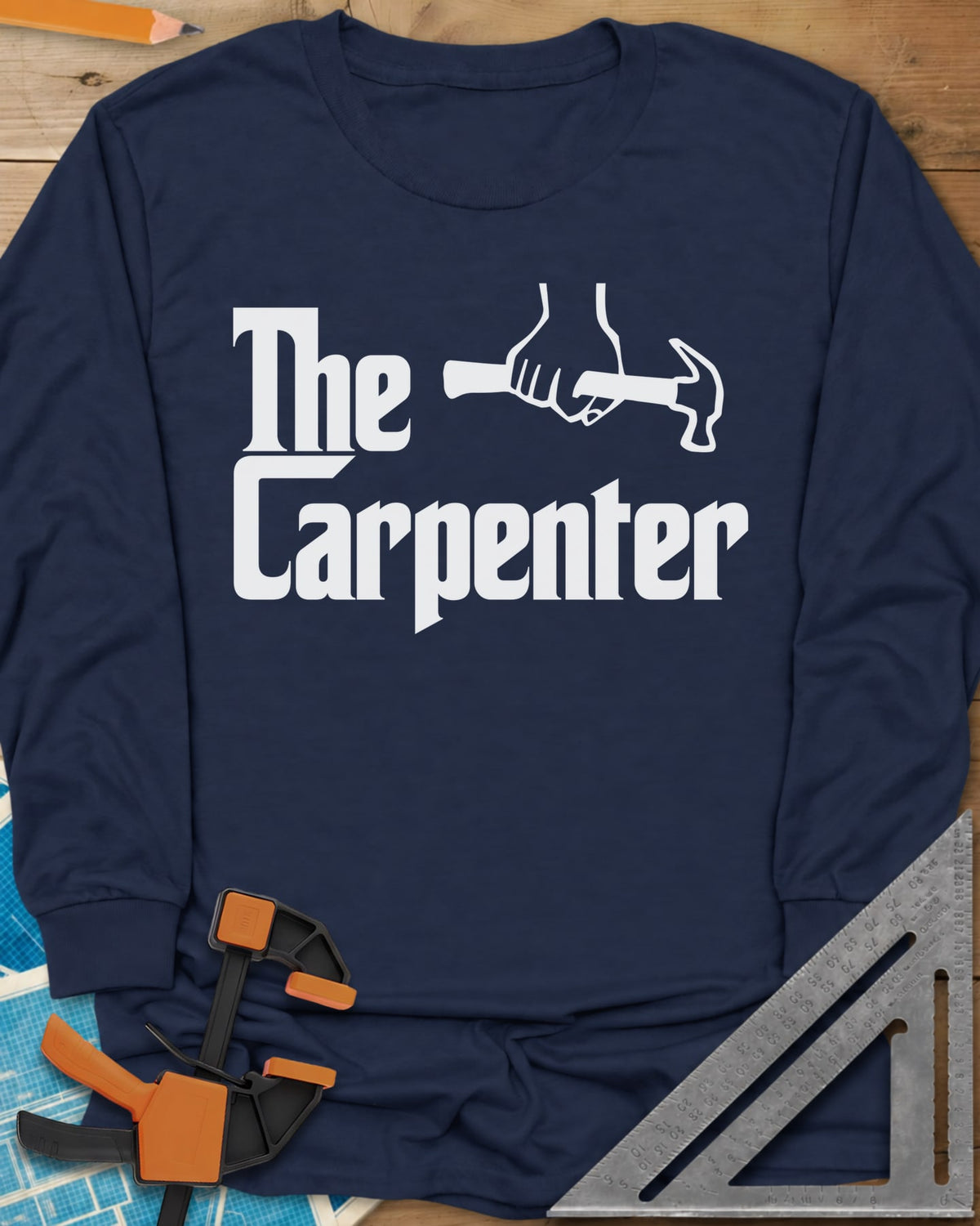 The Carpenter long sleeve shirt in Navy, film-poster style lettering with a fist gripping a hammer