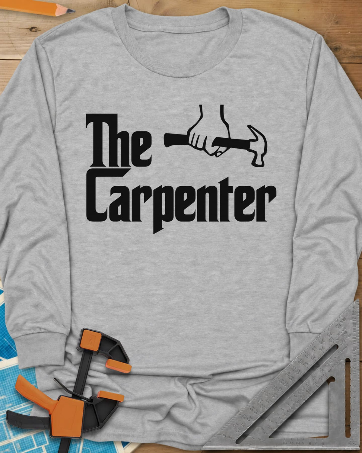 The Carpenter long sleeve shirt in Sport Grey, film-poster style lettering with a fist gripping a hammer