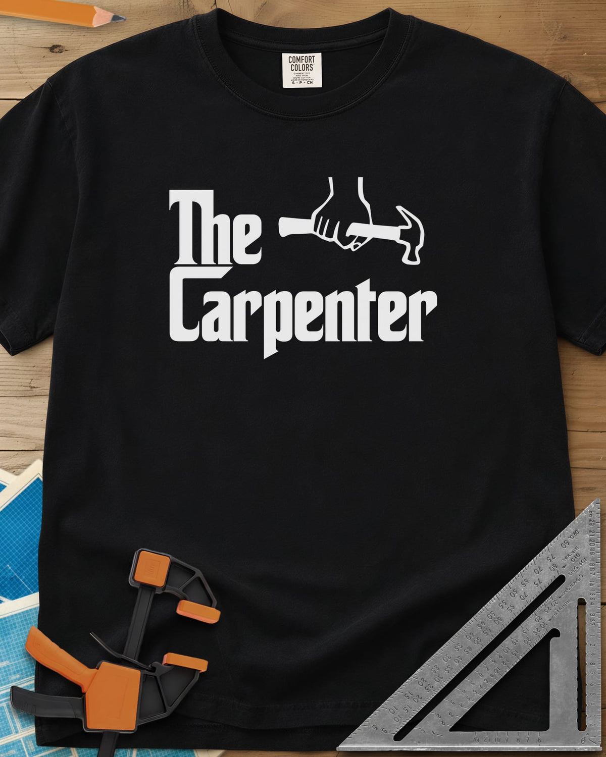 The Carpenter heavyweight tee in Black, film-poster style lettering with a fist gripping a hammer