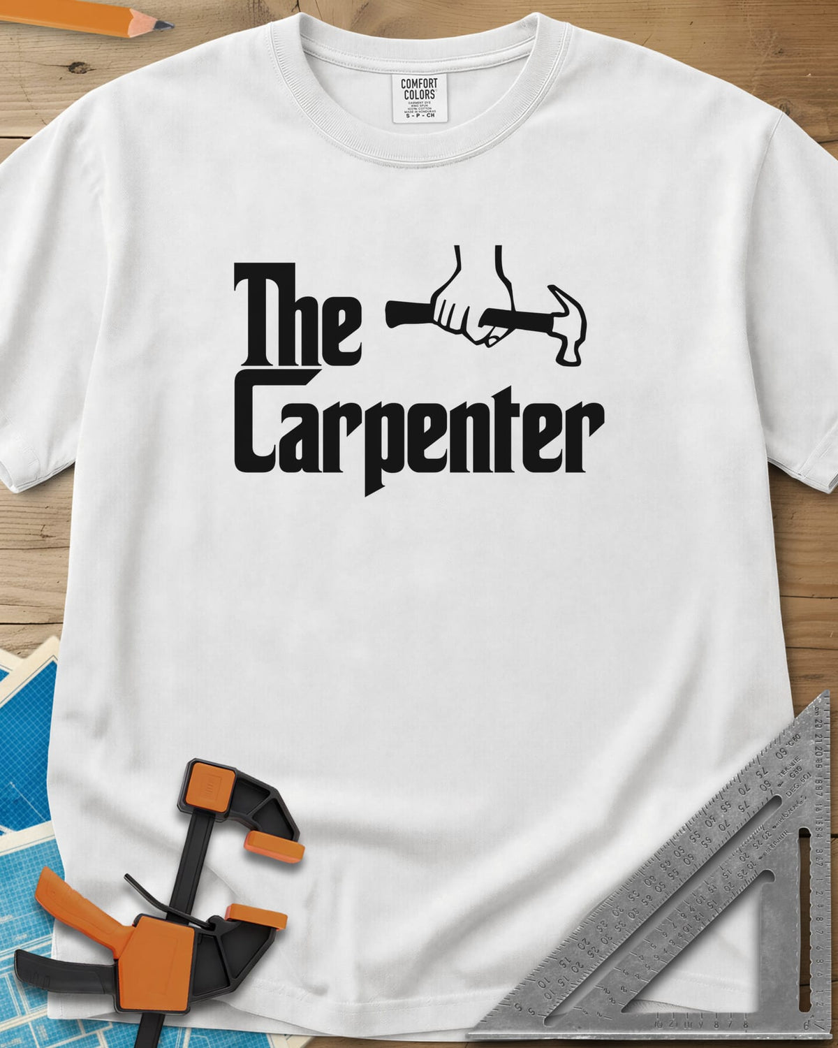 The Carpenter heavyweight tee in White, film-poster style lettering with a fist gripping a hammer