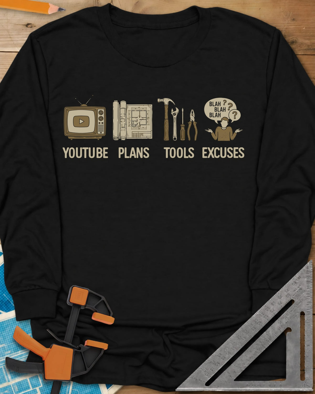 The DIY Loop long sleeve shirt in Black, a retro TV, rolled plans, hand tools and a shrugging figure