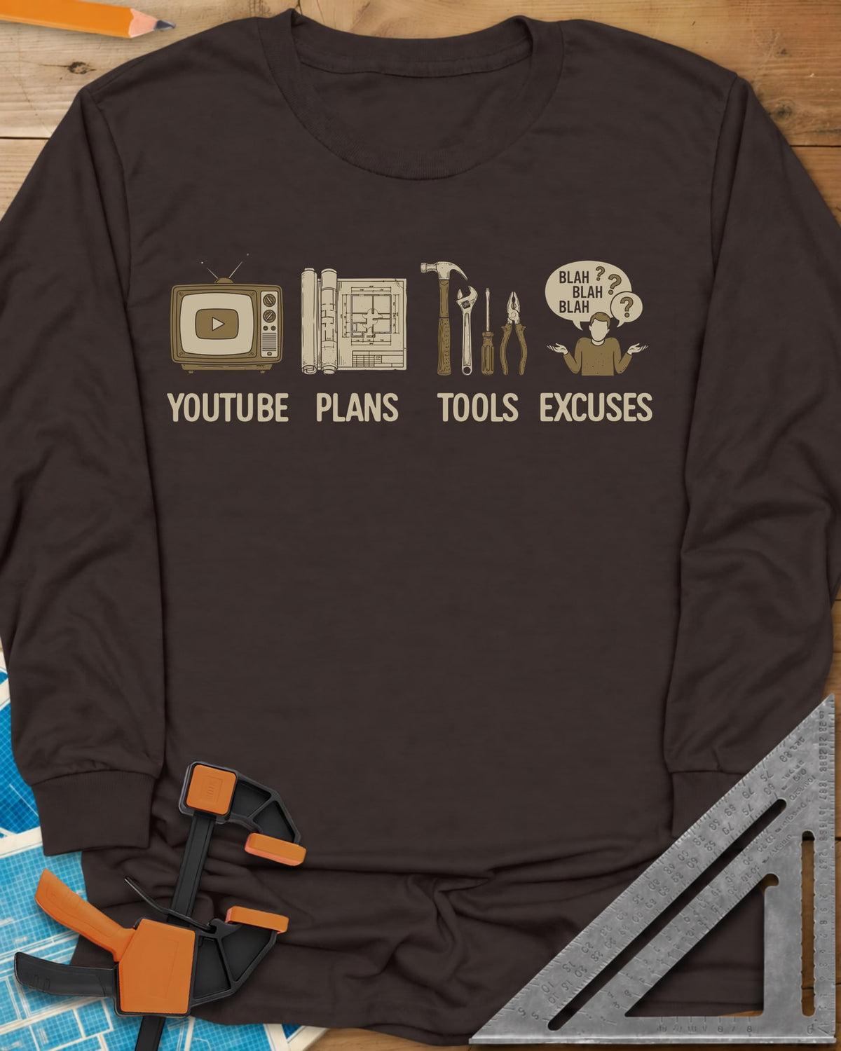 The DIY Loop long sleeve shirt in Dark Chocolate, a retro TV, rolled plans, hand tools and a shrugging figure