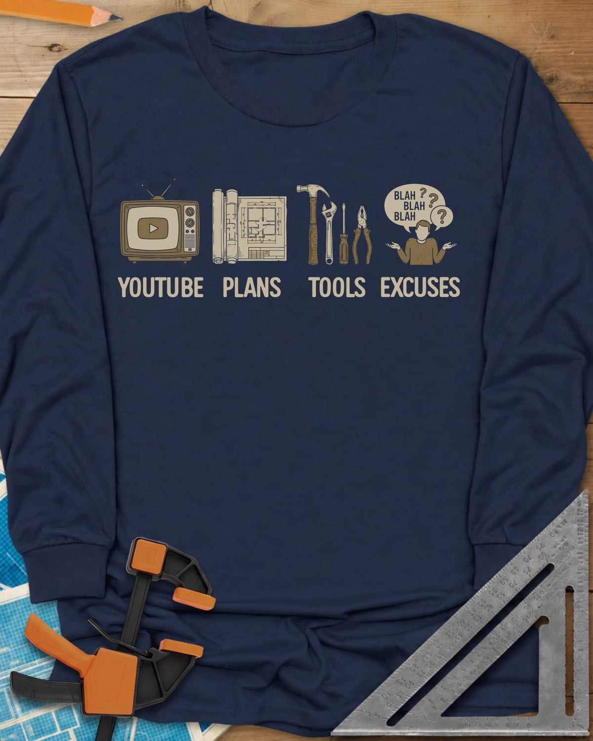 The DIY Loop long sleeve shirt in Navy, a retro TV, rolled plans, hand tools and a shrugging figure