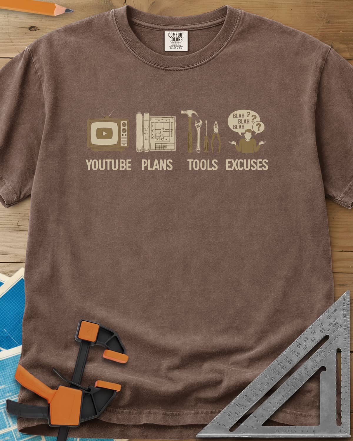 The DIY Loop heavyweight tee in Espresso, a retro TV, rolled plans, hand tools and a shrugging figure