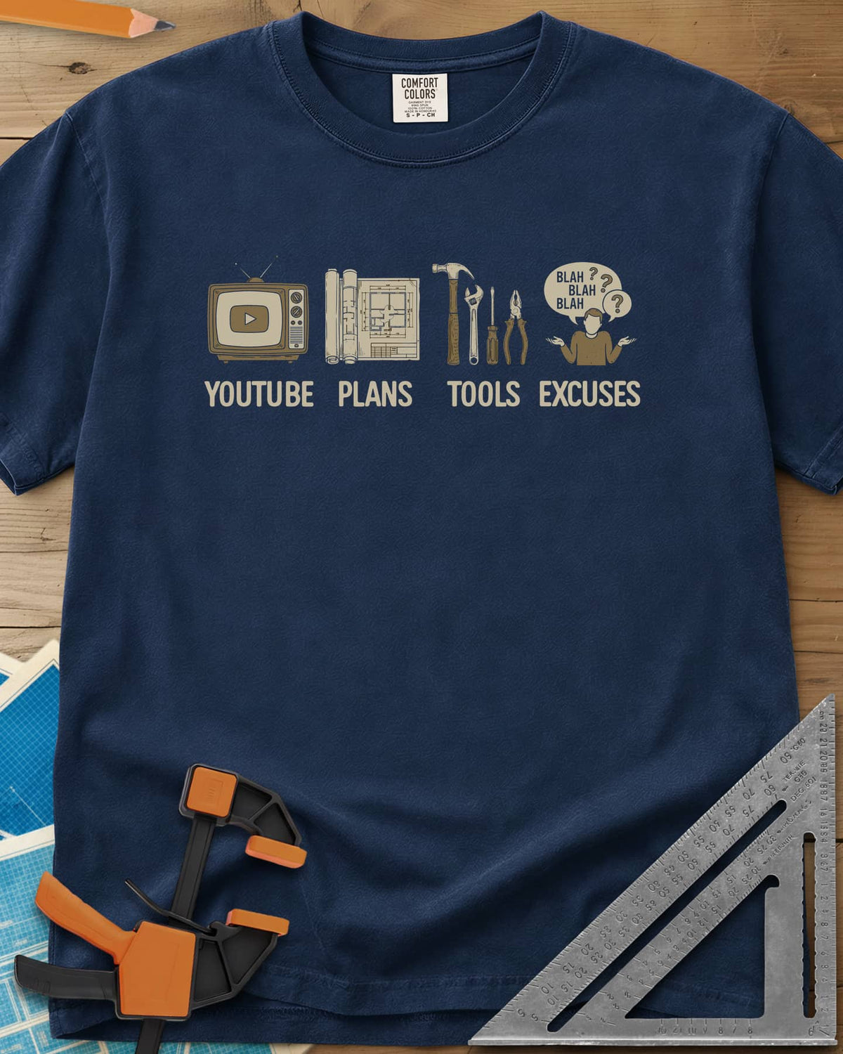 The DIY Loop heavyweight tee in Navy, a retro TV, rolled plans, hand tools and a shrugging figure